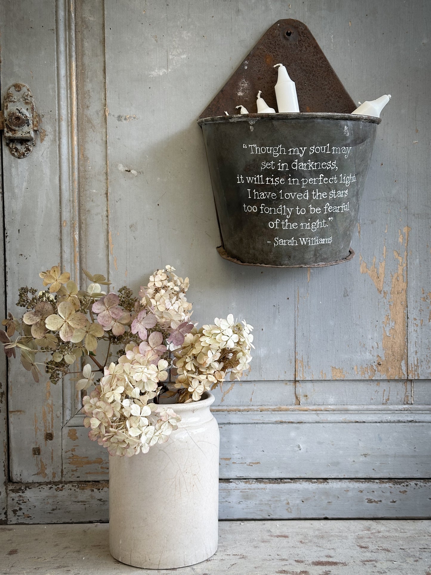 A Recycled Metal Candle Store With A Hand Painted Quote