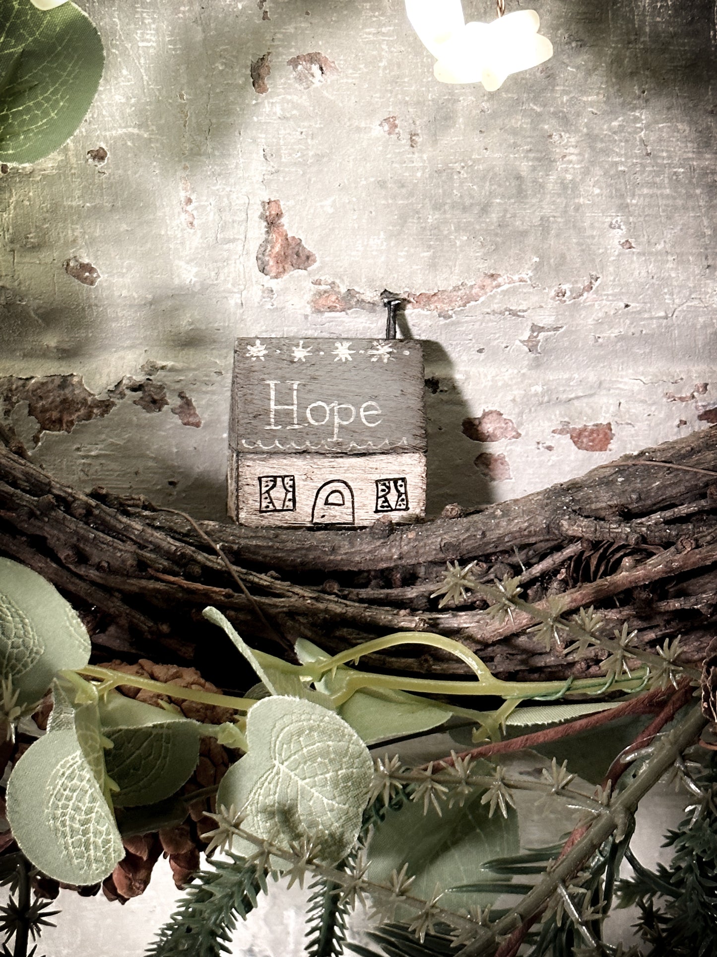 A pretty vintage German Erzgebirge Putz wooden village house painted with a Christmas quote
