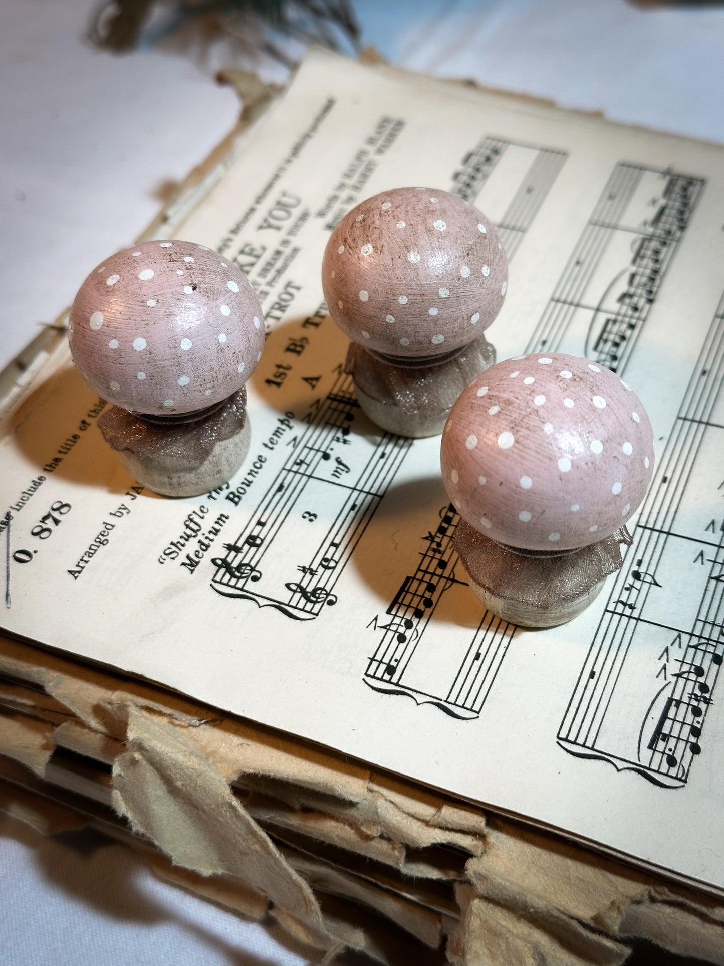 A wooden hand painted and trimmed Christmas village toadstool