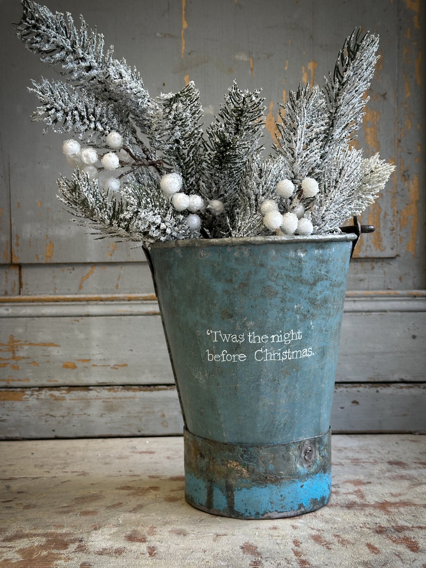 A Recycled Metal Mini Christmas Tree Bucket With A Hand Painted Quote