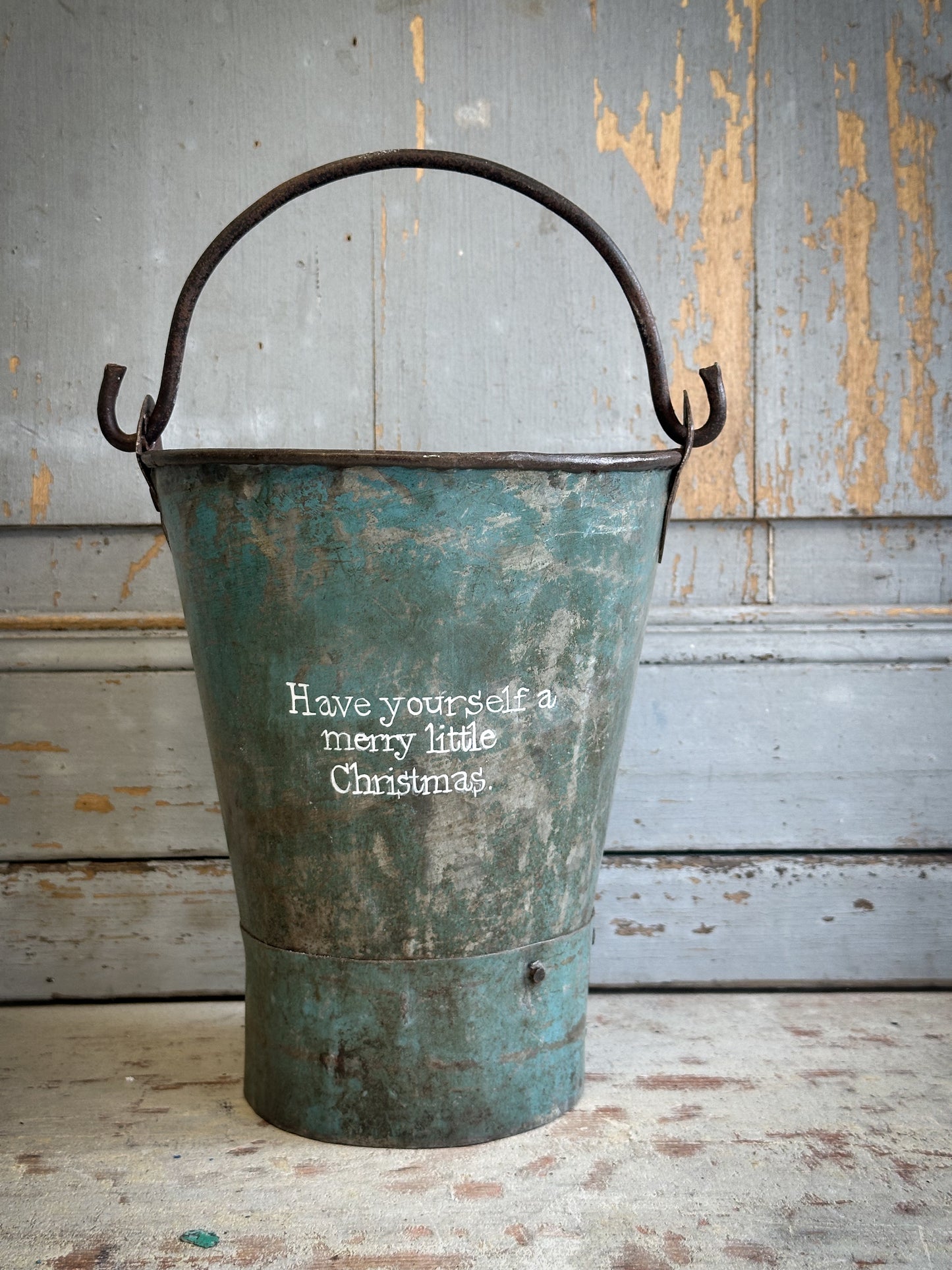 A Recycled Metal Mini Christmas Tree Bucket With A Hand Painted Quote