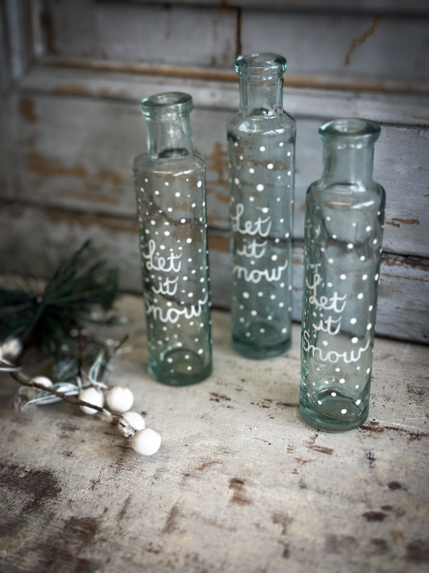 A beautiful Victorian cylinder bottle painted with a Christmas quote “Let it Snow”