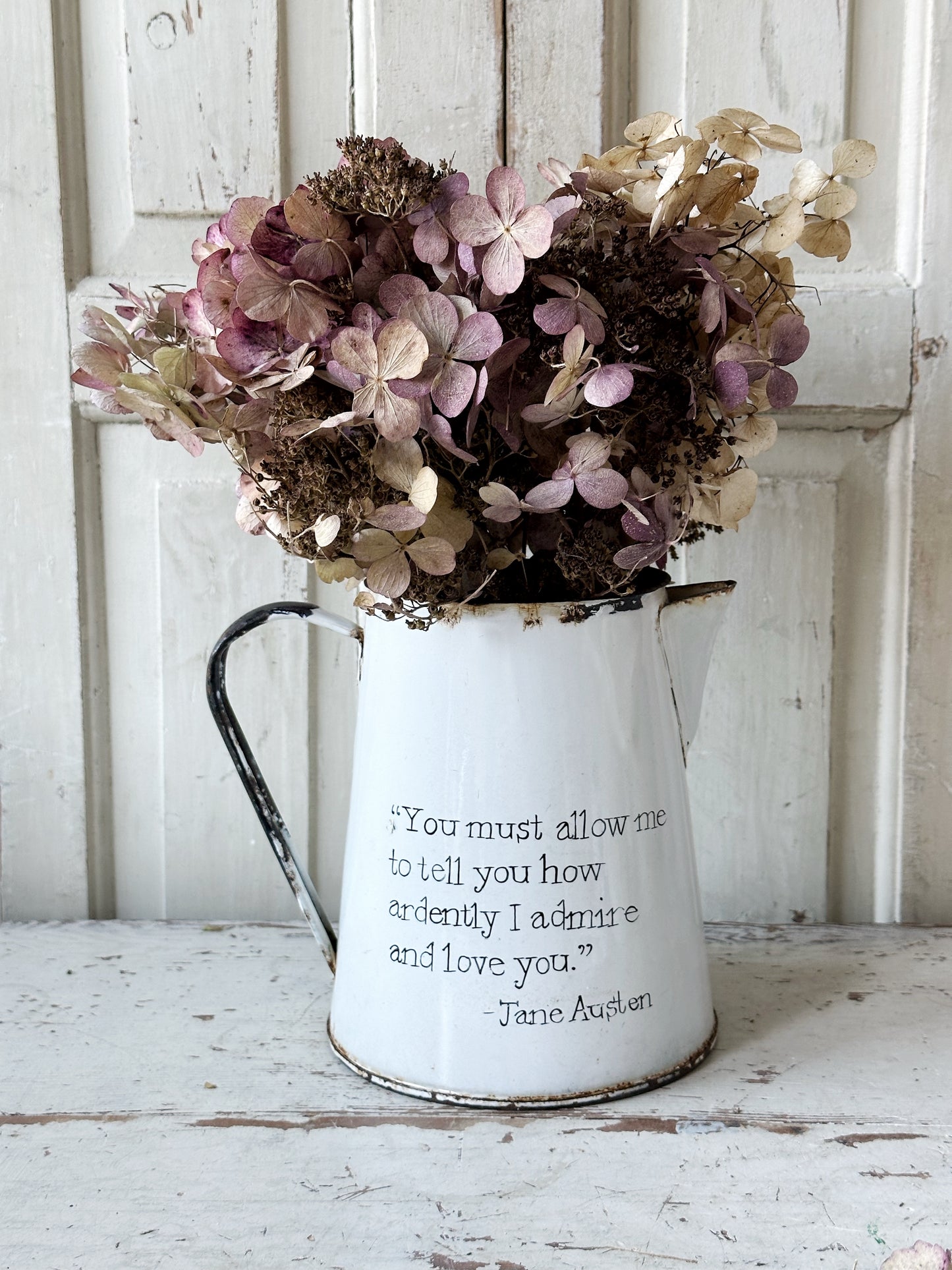 A hand painted quote on a beautiful Vintage white enamelware jug