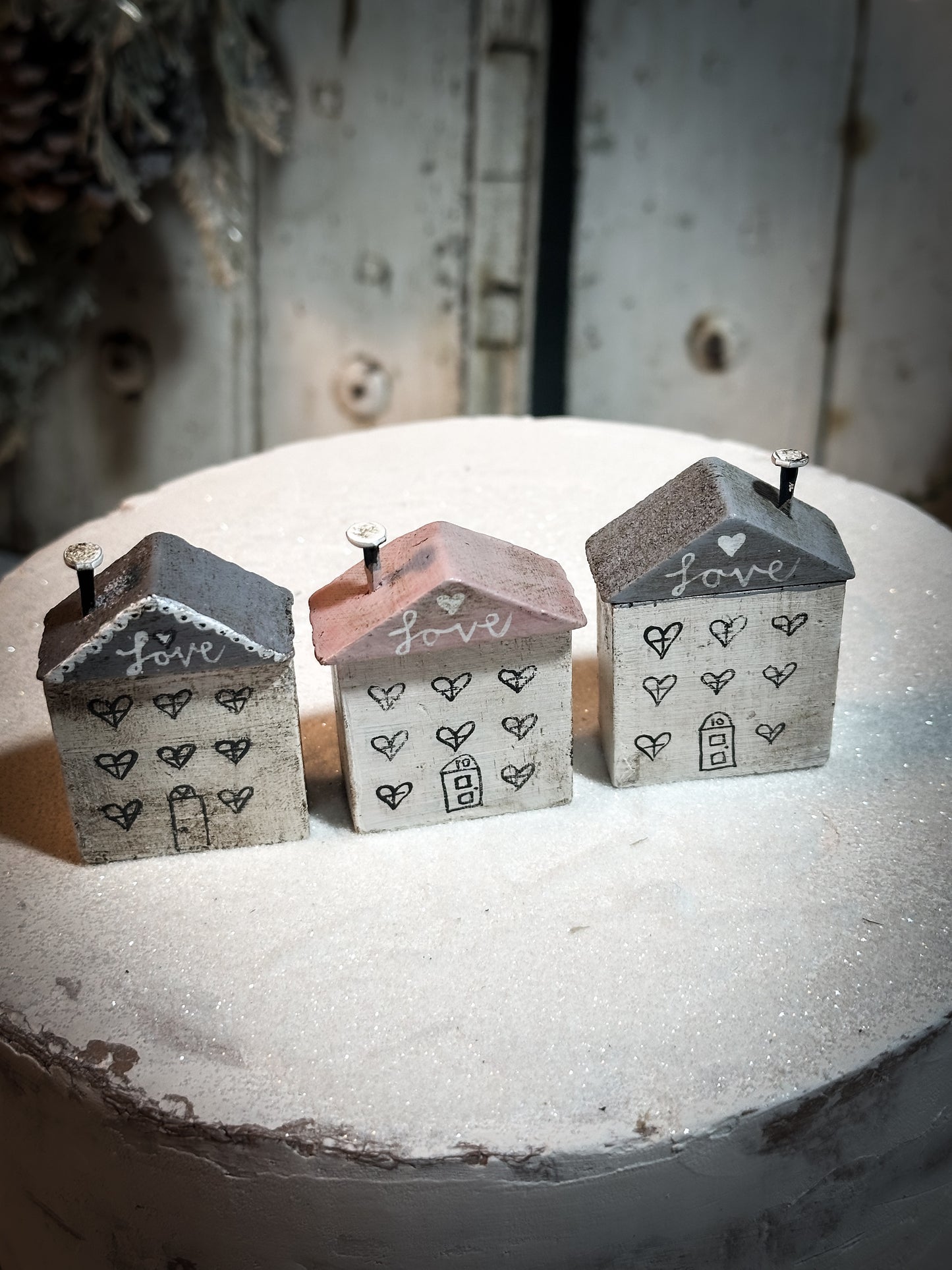 A pretty vintage German Erzgebirge Putz wooden village house painted with a Christmas quote