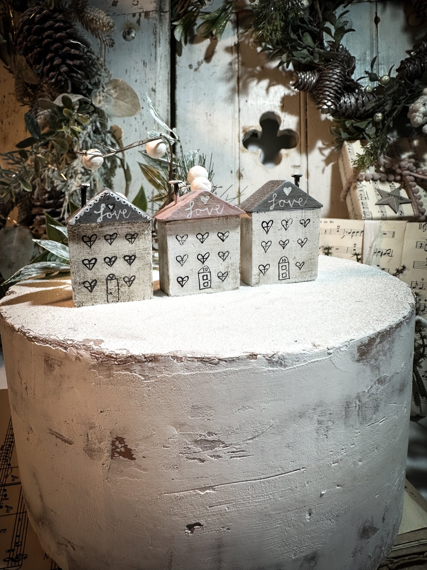 A pretty vintage German Erzgebirge Putz wooden village house painted with a Christmas quote