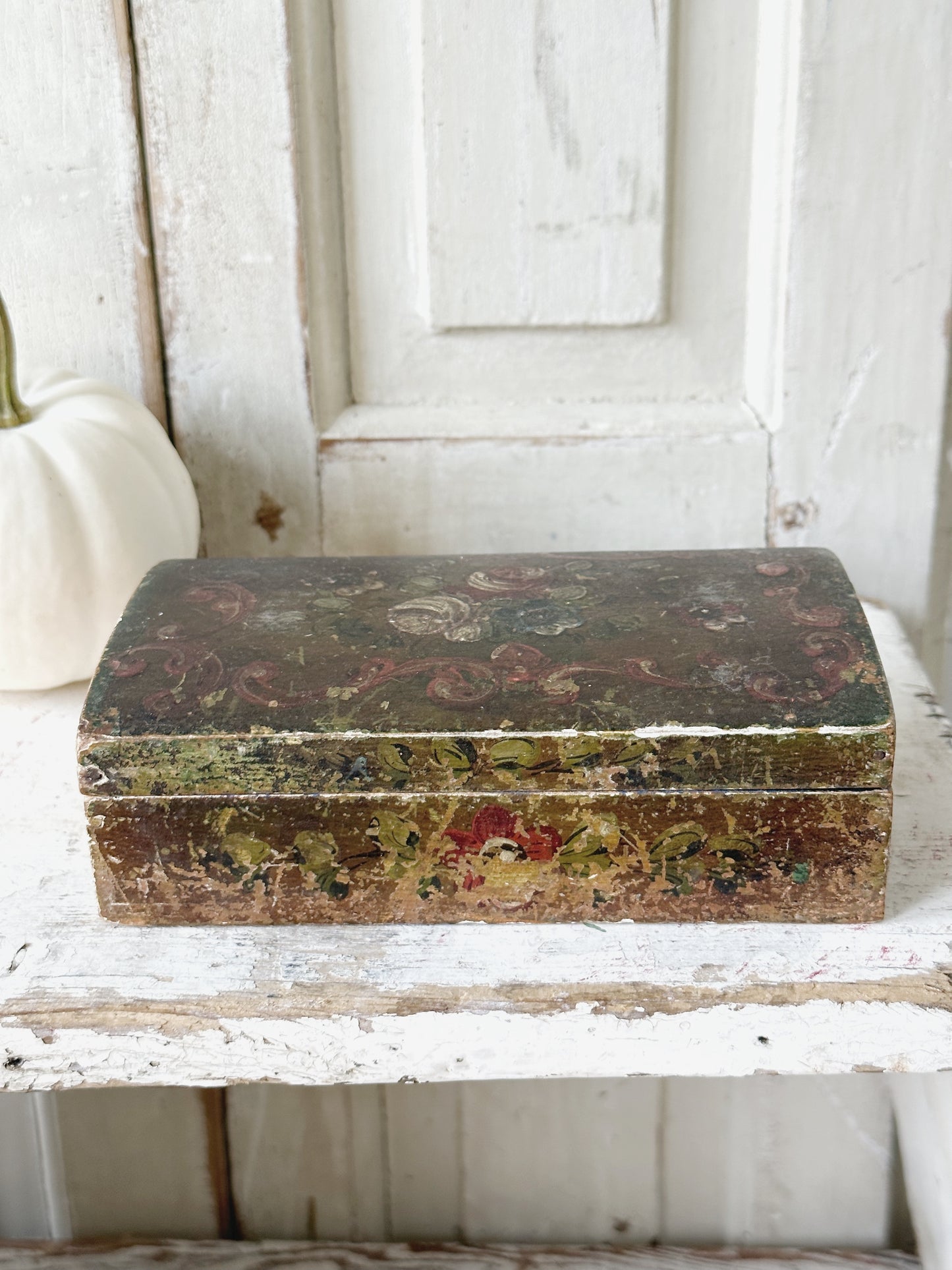 A beautiful antique painted box with floral detail