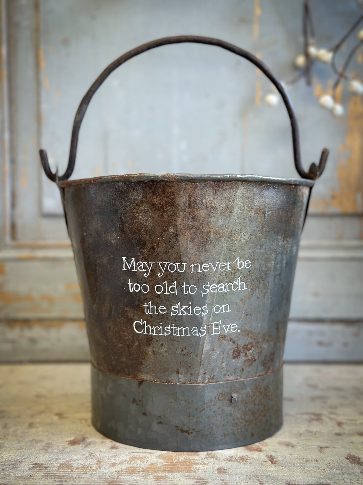 A Recycled Metal Small Christmas Tree Bucket With A Hand Painted Quote