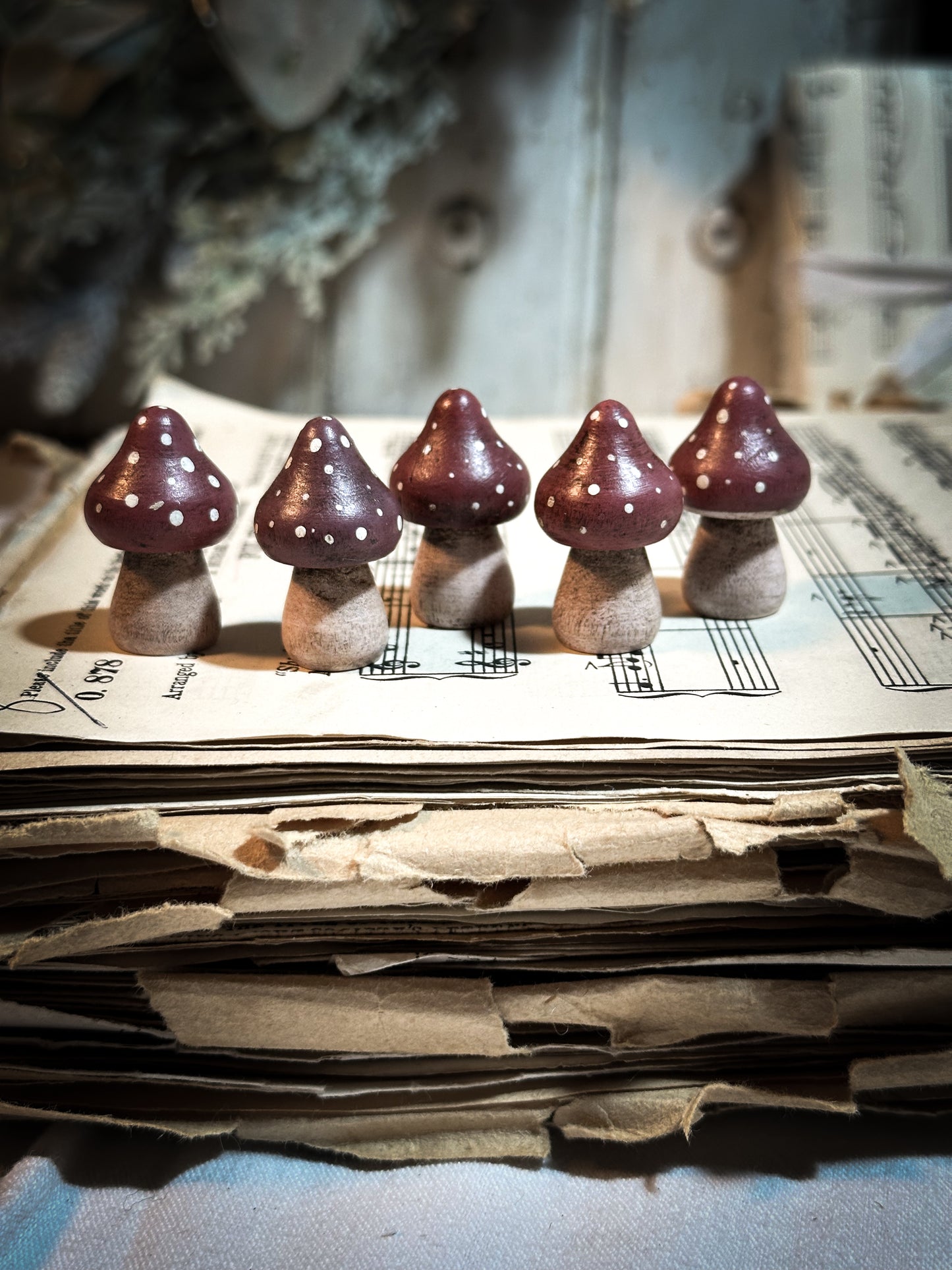 A wooden hand painted and trimmed Christmas village toadstool