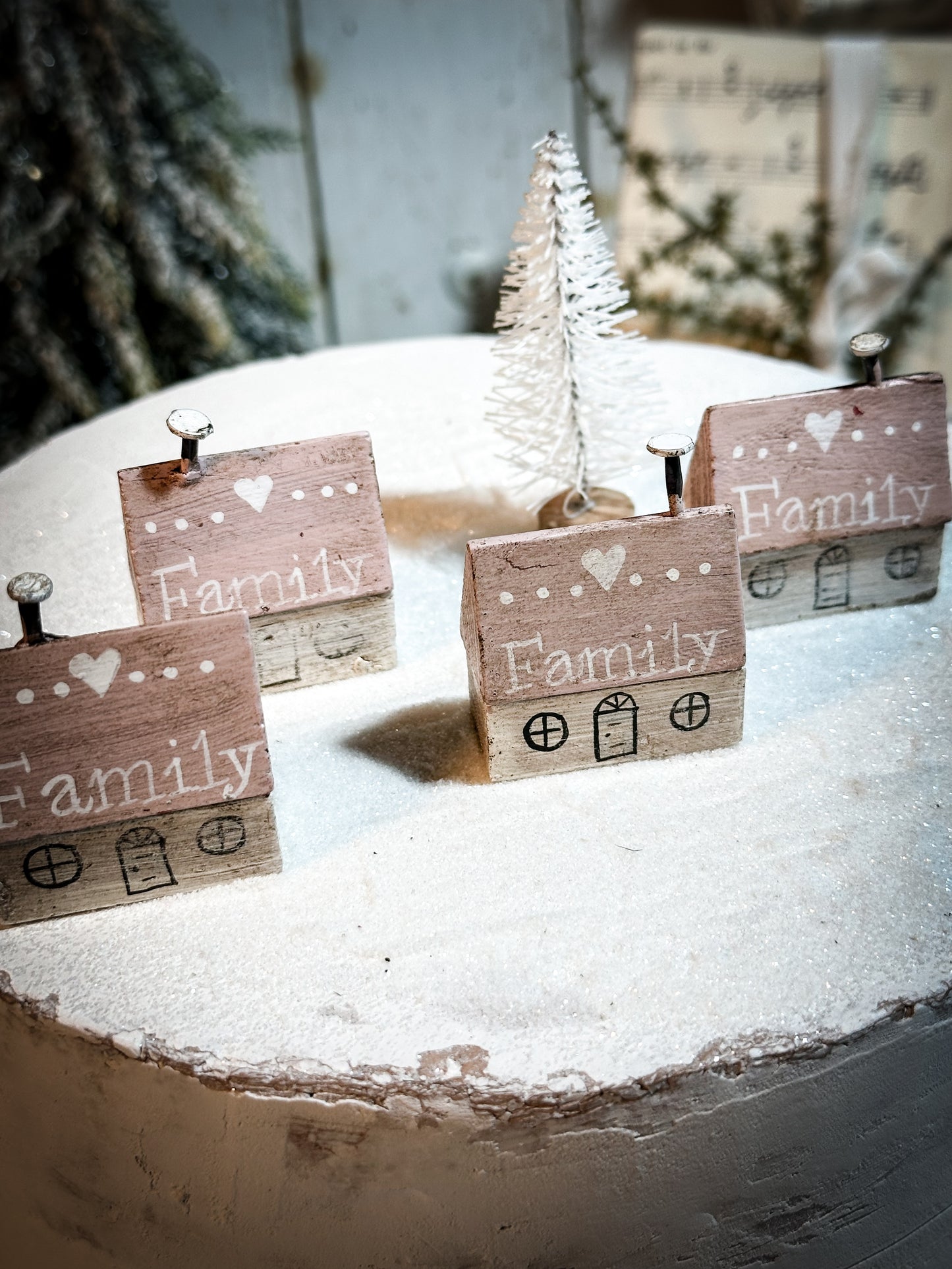 A pretty vintage German Erzgebirge Putz wooden village house painted with a Christmas quote