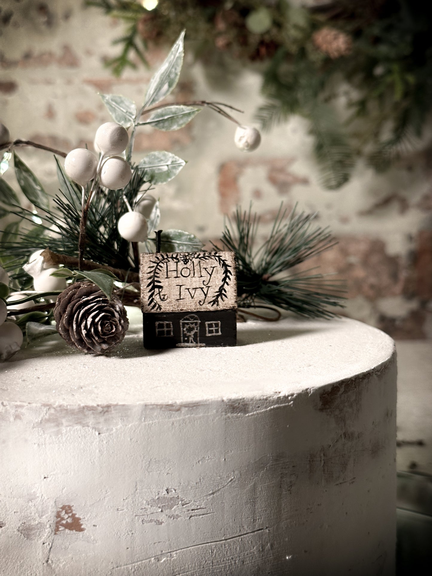 A pretty vintage German Erzgebirge Putz wooden village house painted with a Christmas quote