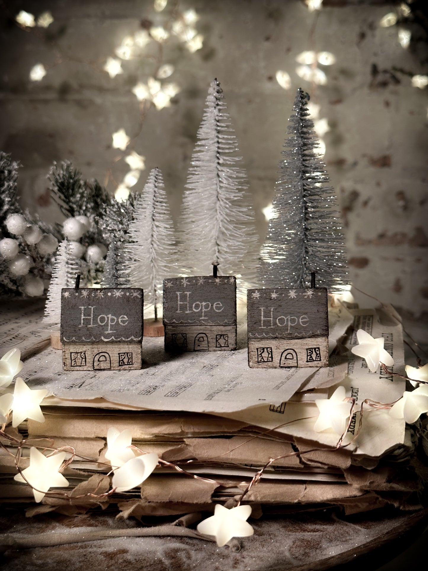 A pretty vintage German Erzgebirge Putz wooden village house painted with a Christmas quote