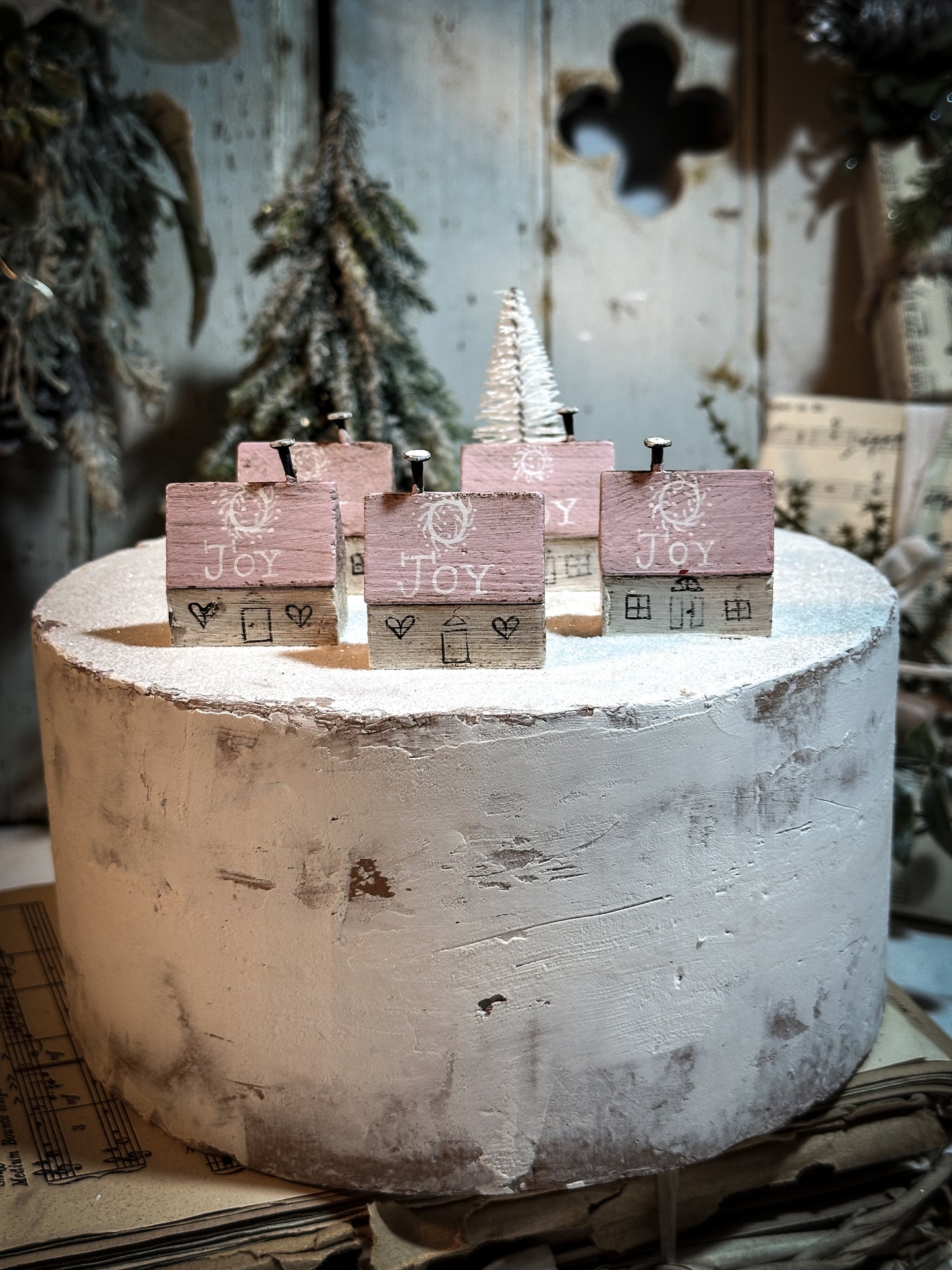 A pretty vintage German Erzgebirge Putz wooden village house painted with a Christmas quote