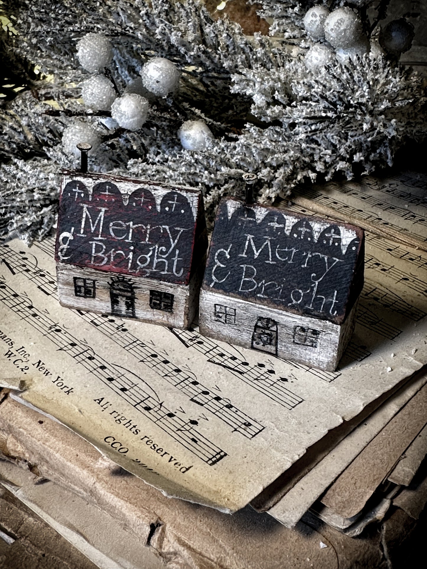 A pretty vintage German Erzgebirge Putz wooden village house painted with a Christmas quote
