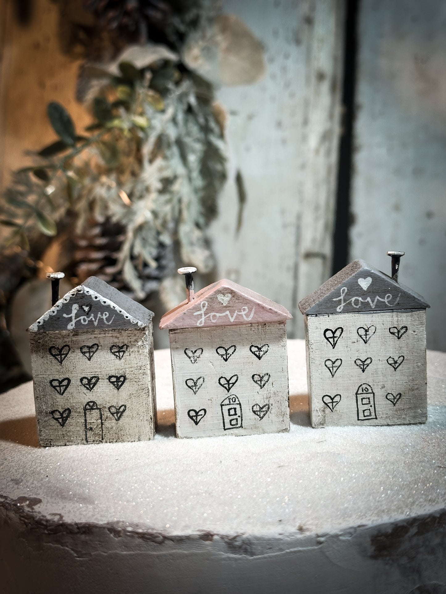 A pretty vintage German Erzgebirge Putz wooden village house painted with a Christmas quote