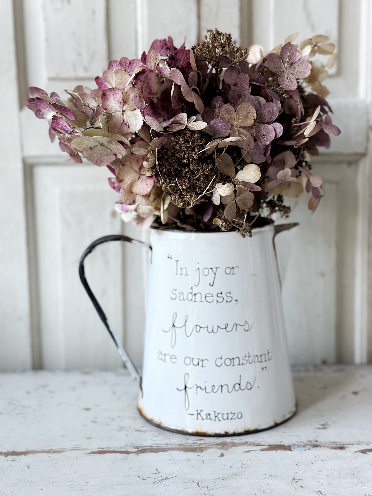 A hand painted quote on a beautiful Vintage white enamelware jug