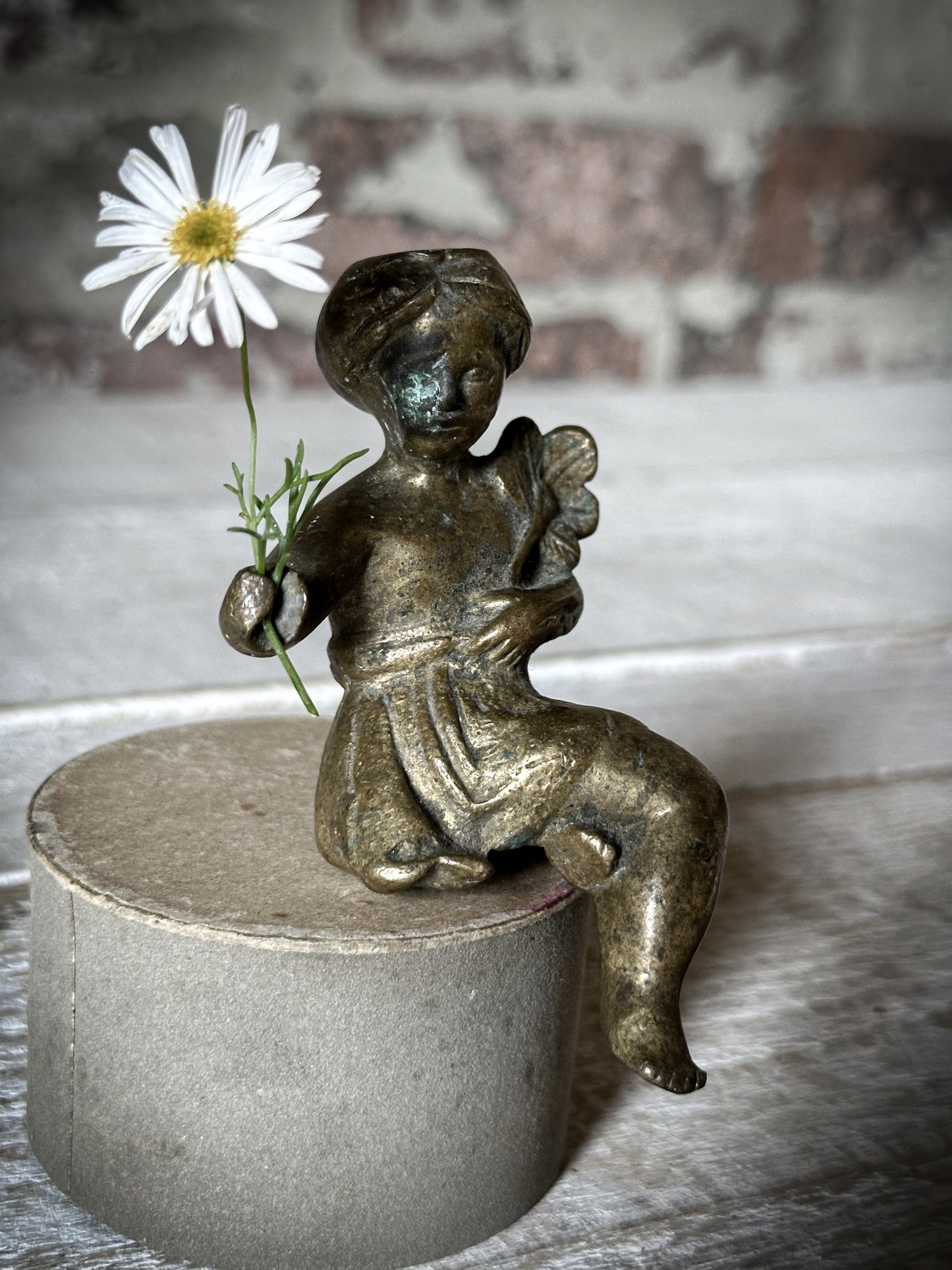 A Delightful Antique Bronze Decorative Seated Cherub