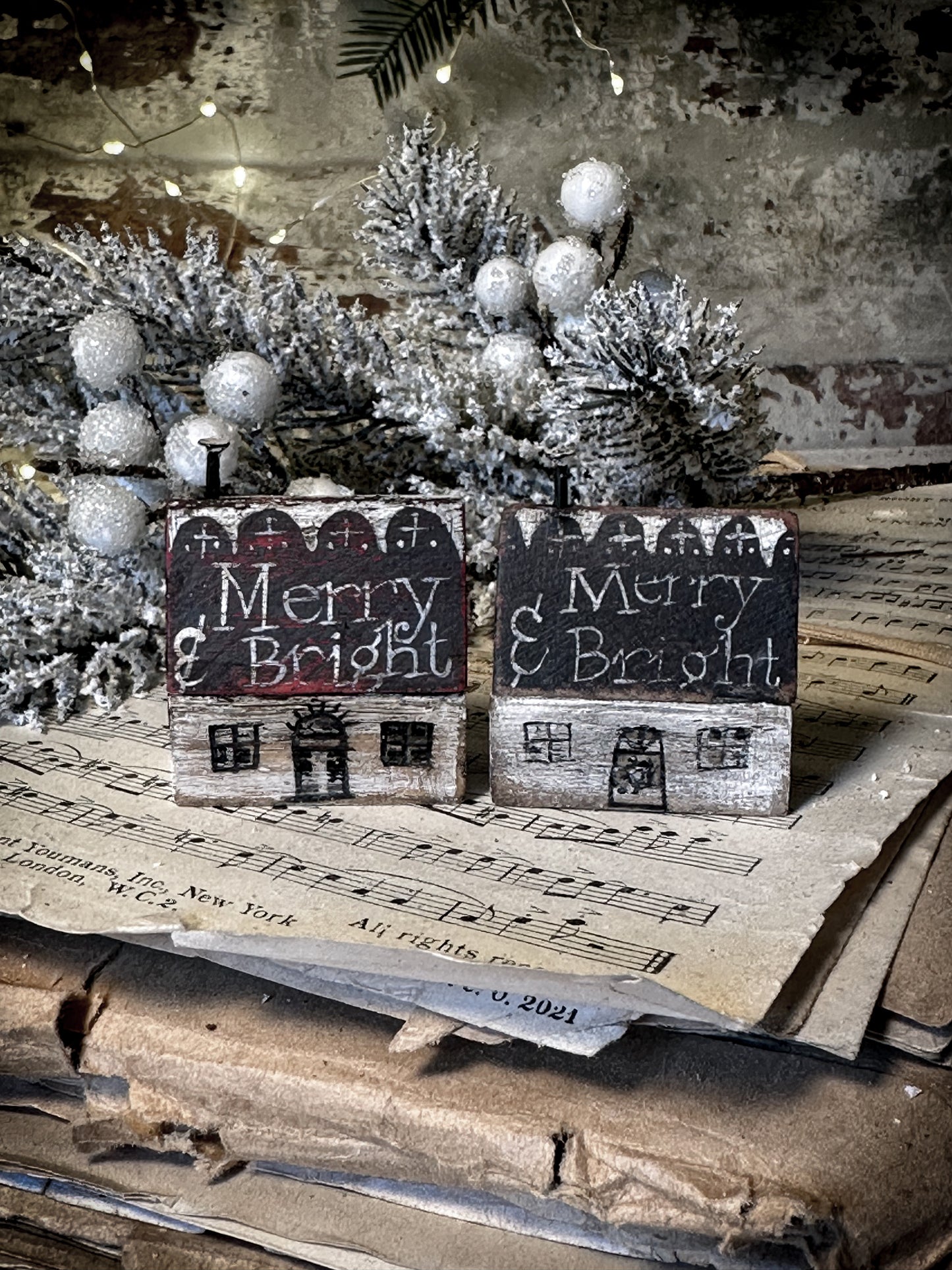 A pretty vintage German Erzgebirge Putz wooden village house painted with a Christmas quote