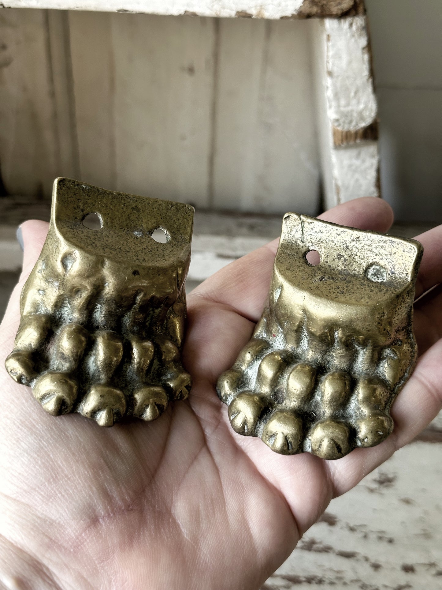 A pair of two antique brass salvaged clawed feet for furniture