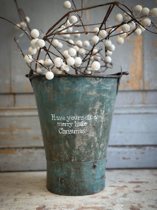 A Recycled Metal Mini Christmas Tree Bucket With A Hand Painted Quote