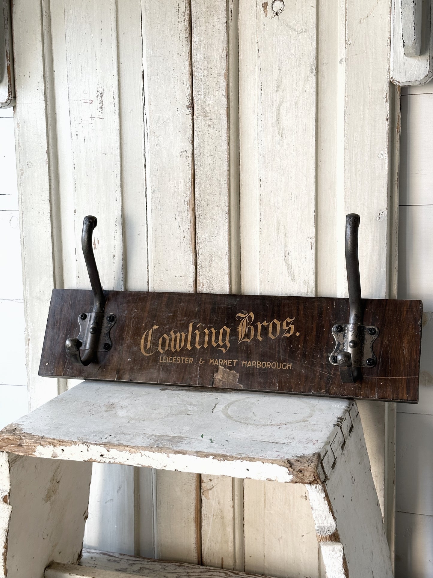 Salvaged sign written drawer front coat pegs