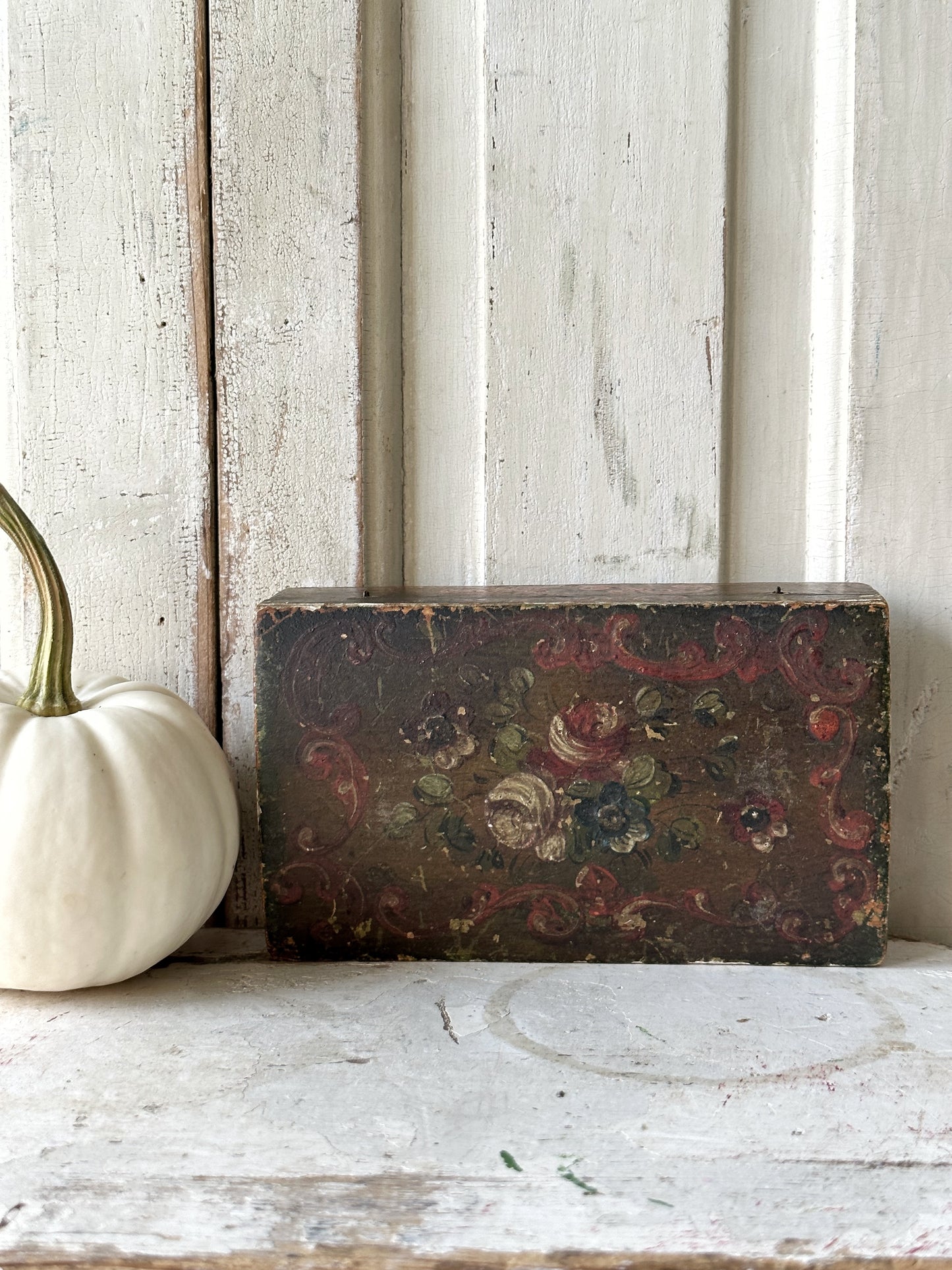 A beautiful antique painted box with floral detail