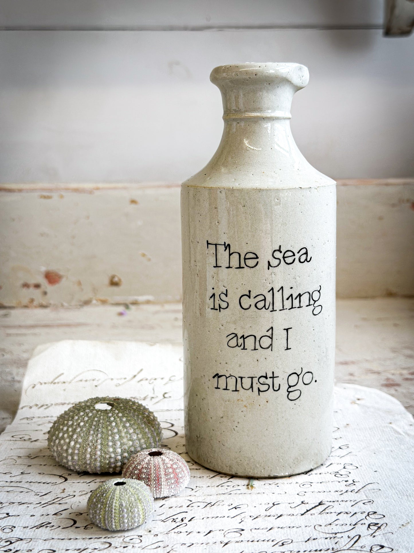 A Victorian unearthed short stoneware pottery bottle with a hand painted quote