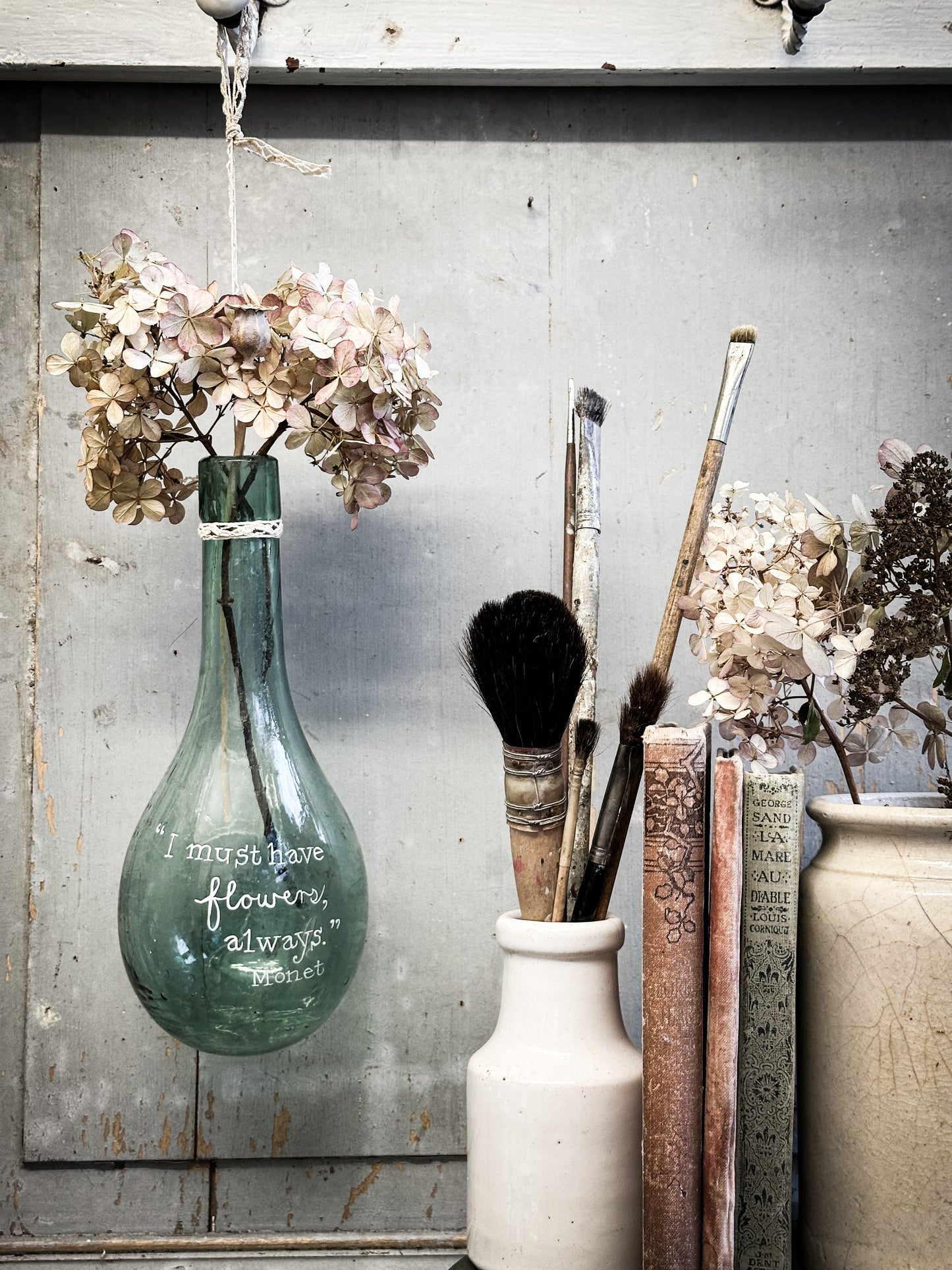A beautiful antique hanging bulb bottle with a hand painted quote