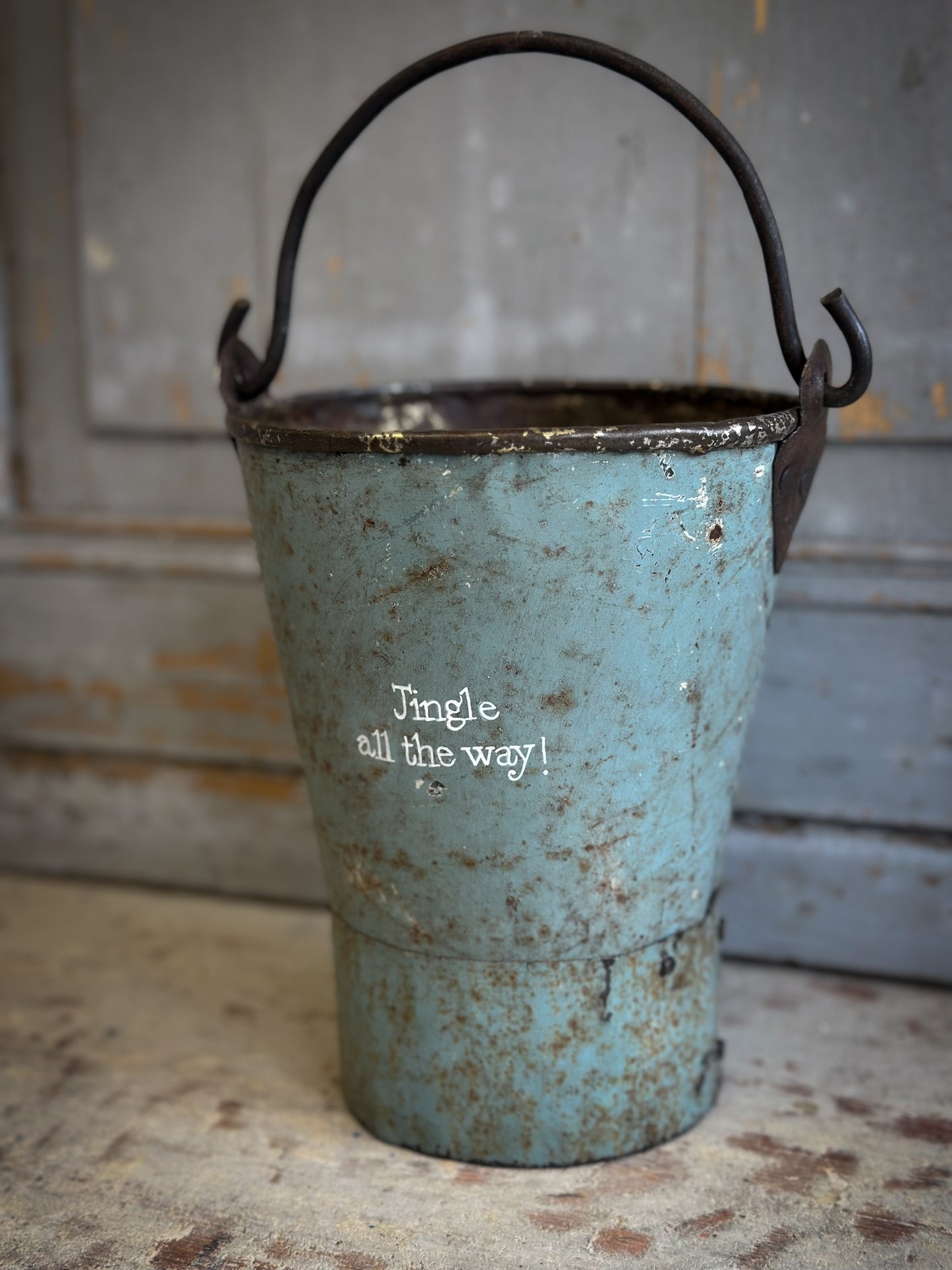 A Recycled Metal Mini Christmas Tree Bucket With A Hand Painted Quote
