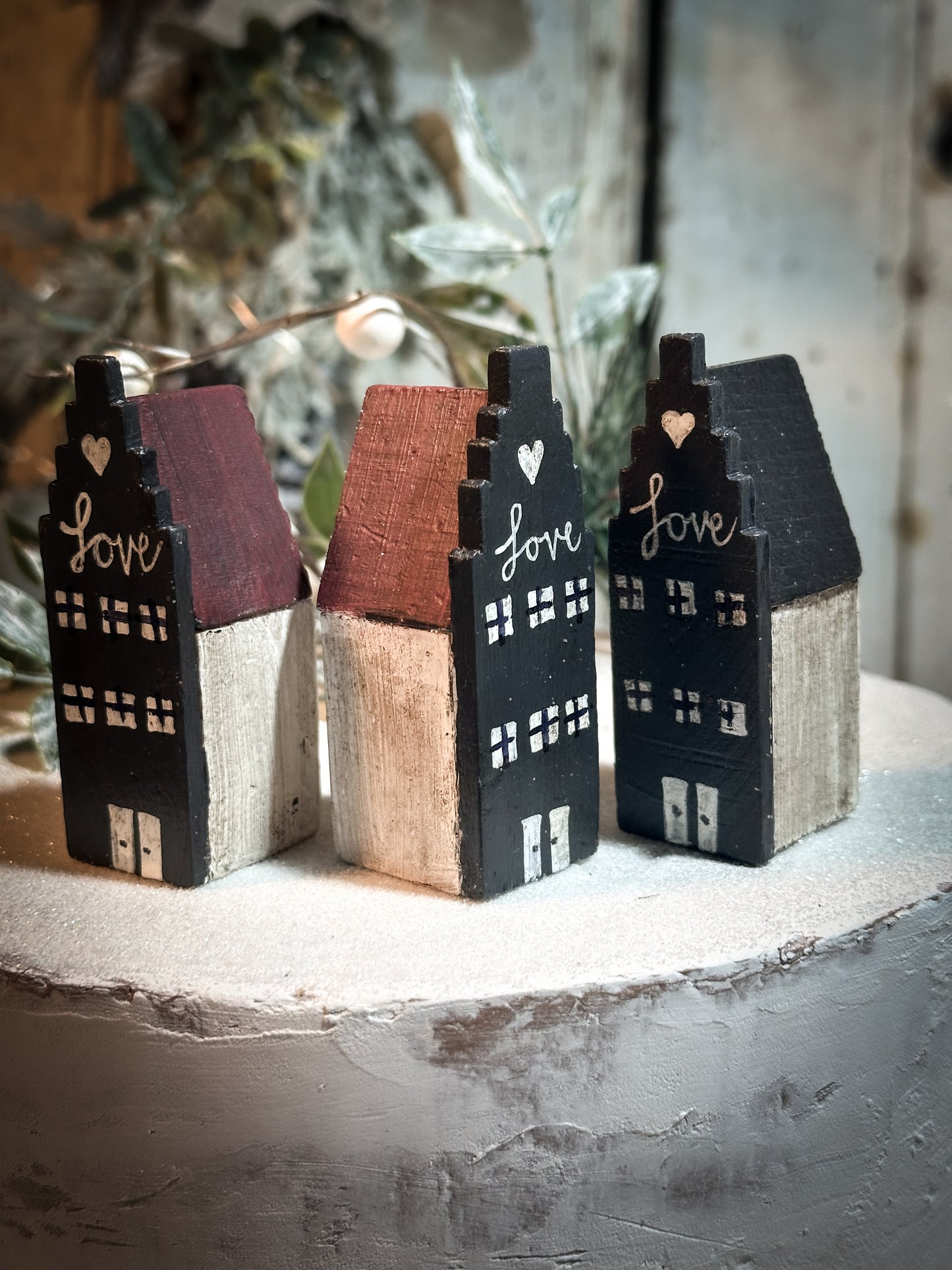 A pretty vintage German Erzgebirge Putz wooden village house painted with a Christmas quote