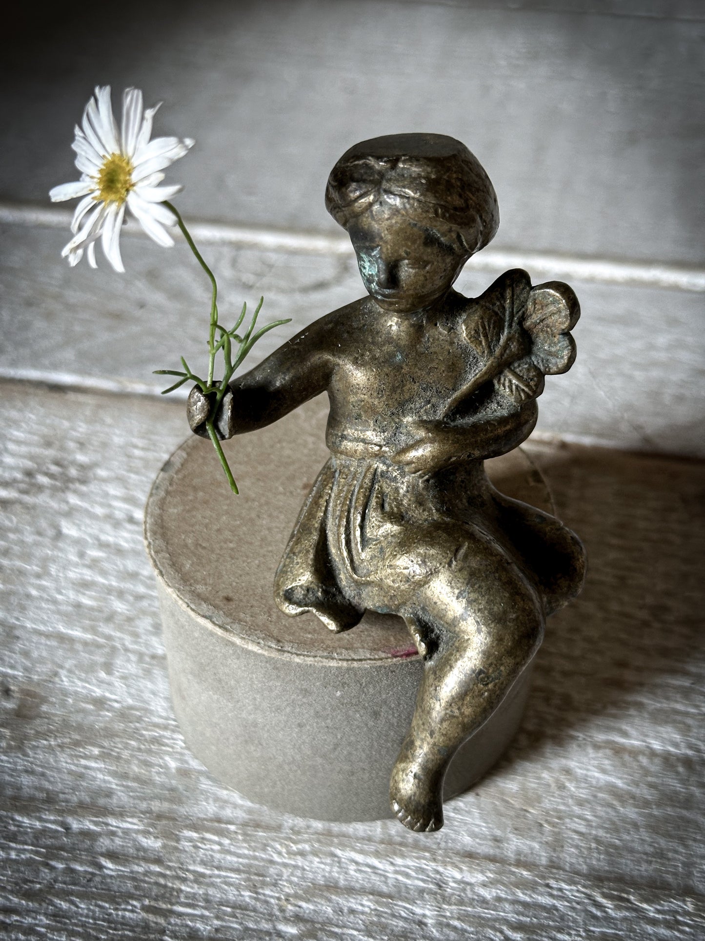 A Delightful Antique Bronze Decorative Seated Cherub