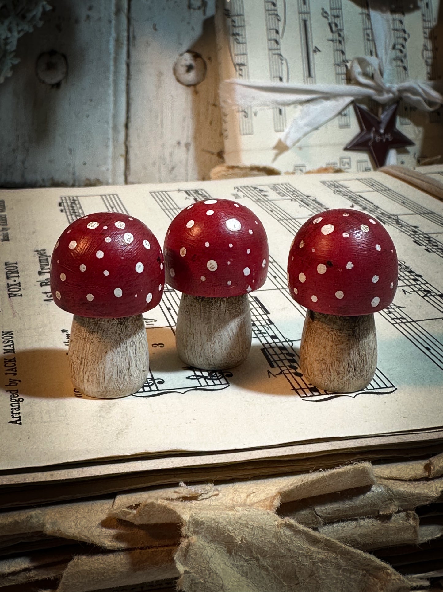 A wooden hand painted Christmas village toadstool