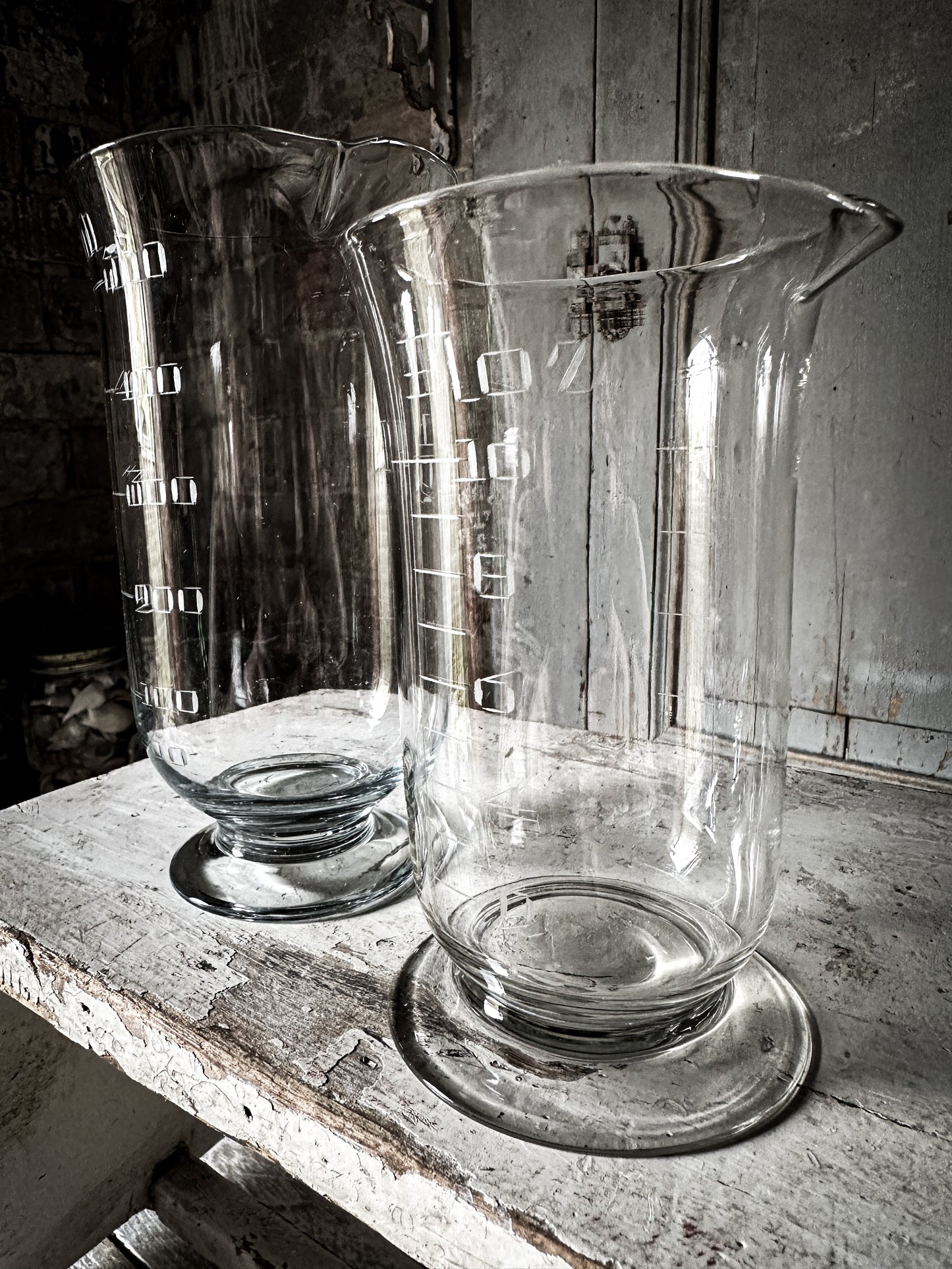 A pair of wonderful antique etched glass apothecary measures