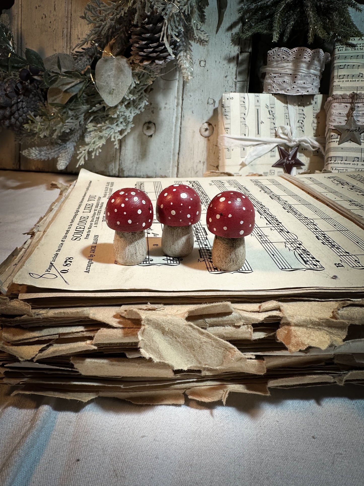 A wooden hand painted Christmas village toadstool
