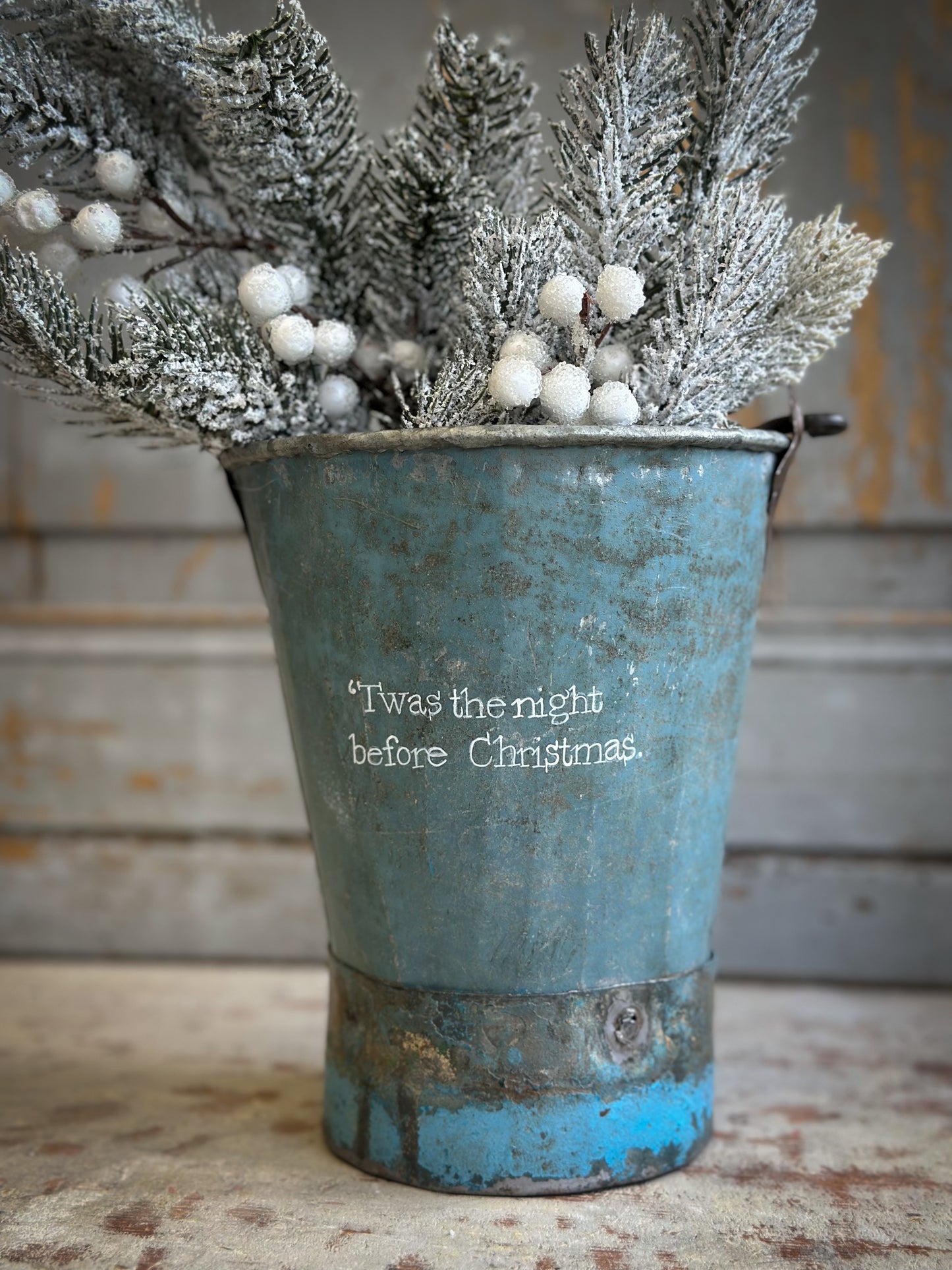A Recycled Metal Mini Christmas Tree Bucket With A Hand Painted Quote