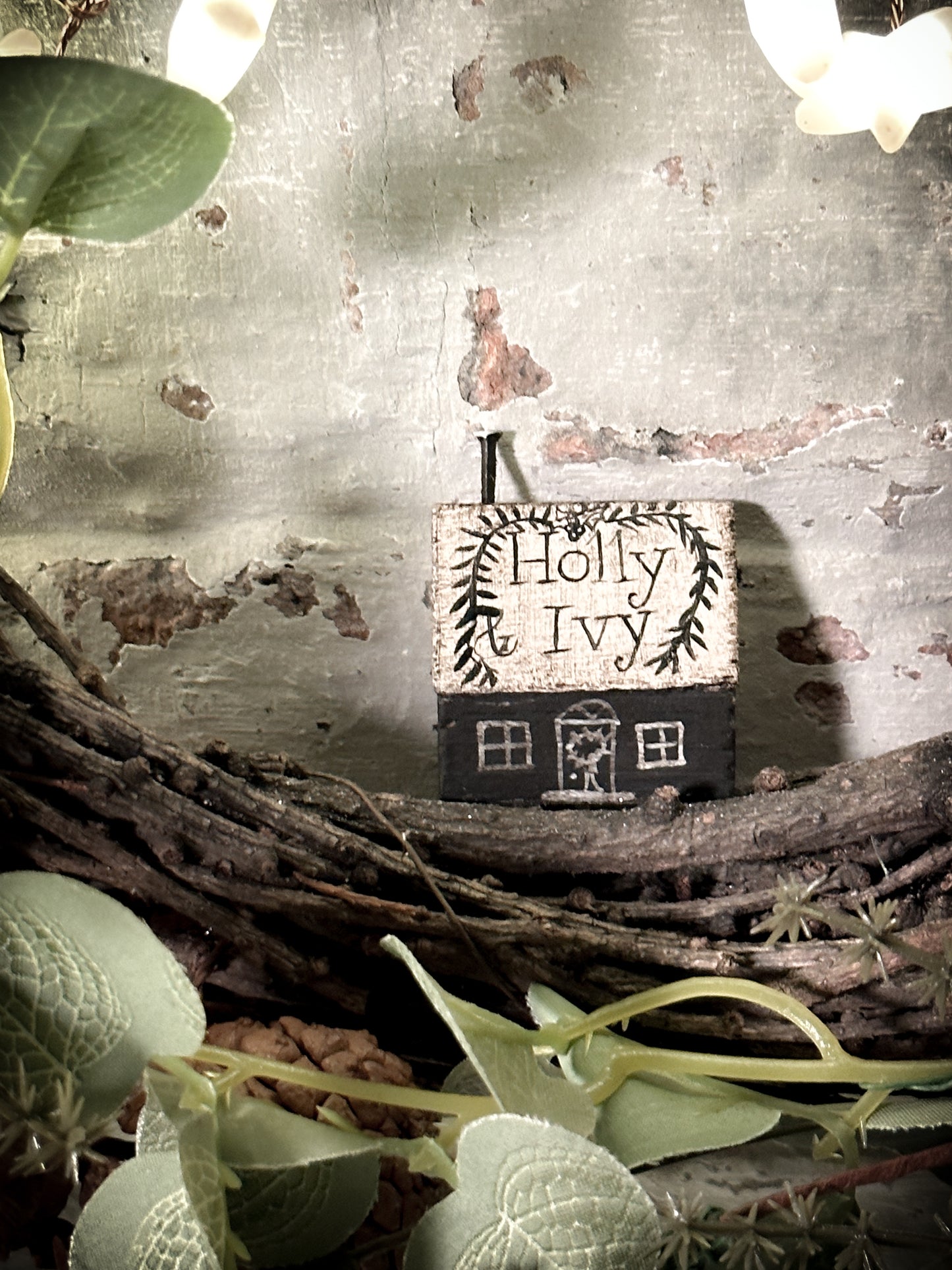 A pretty vintage German Erzgebirge Putz wooden village house painted with a Christmas quote
