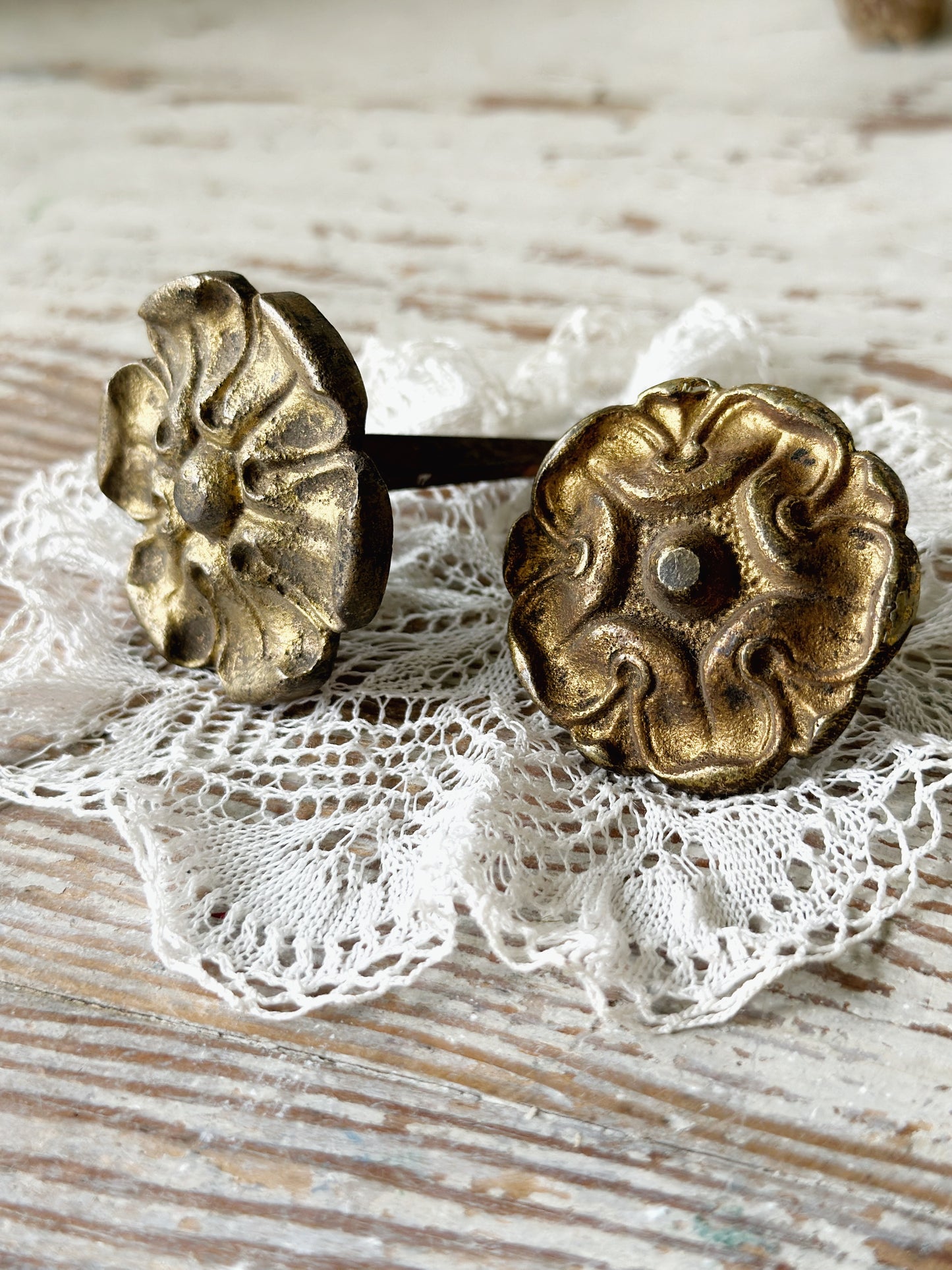 A pair of antique brass salvaged French curtain tie back hooks