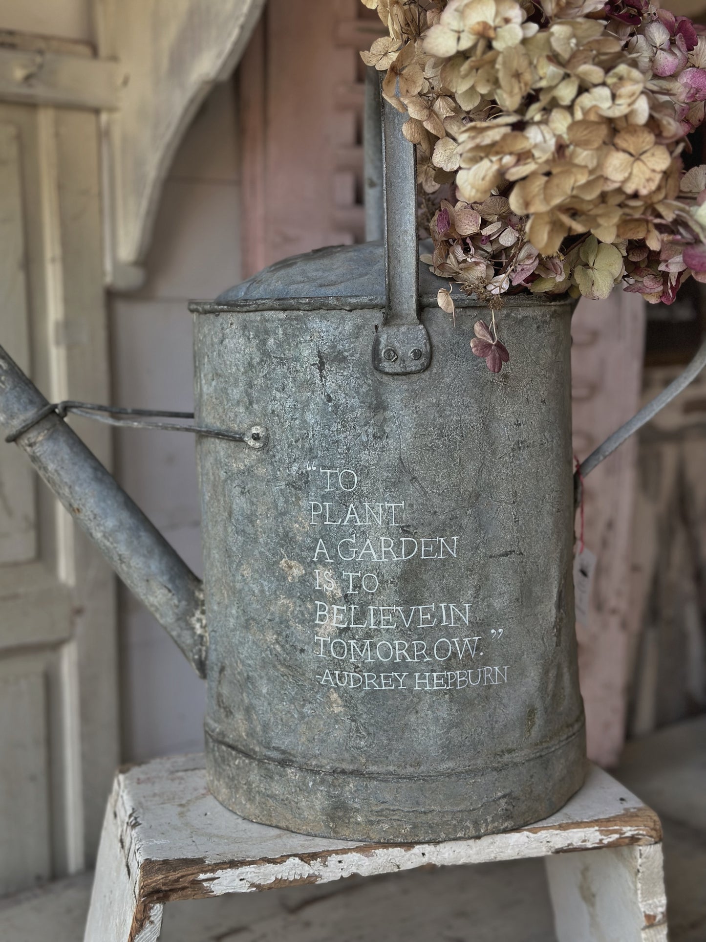 A beautiful vintage galvanised watering can planter
