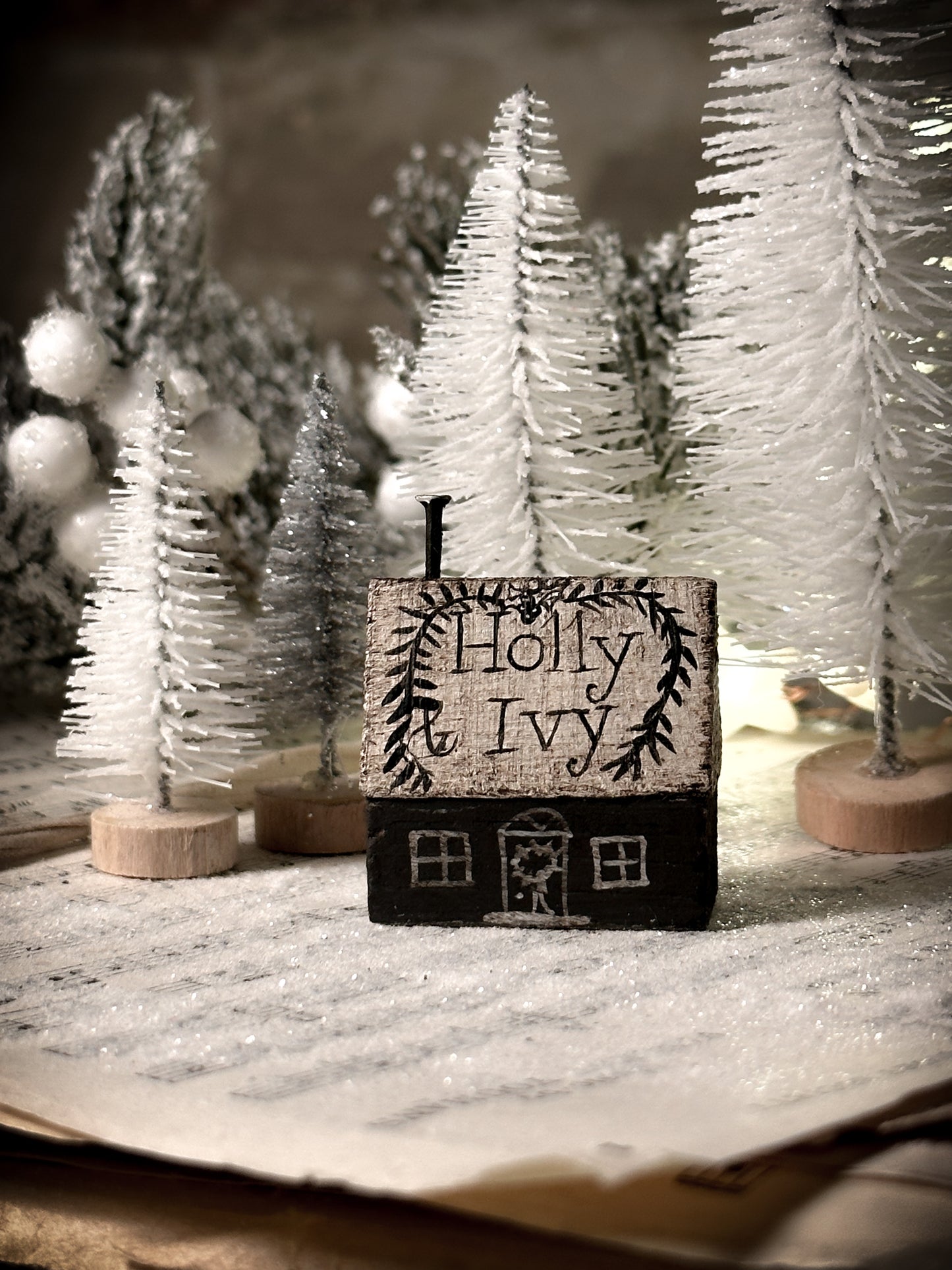 A pretty vintage German Erzgebirge Putz wooden village house painted with a Christmas quote