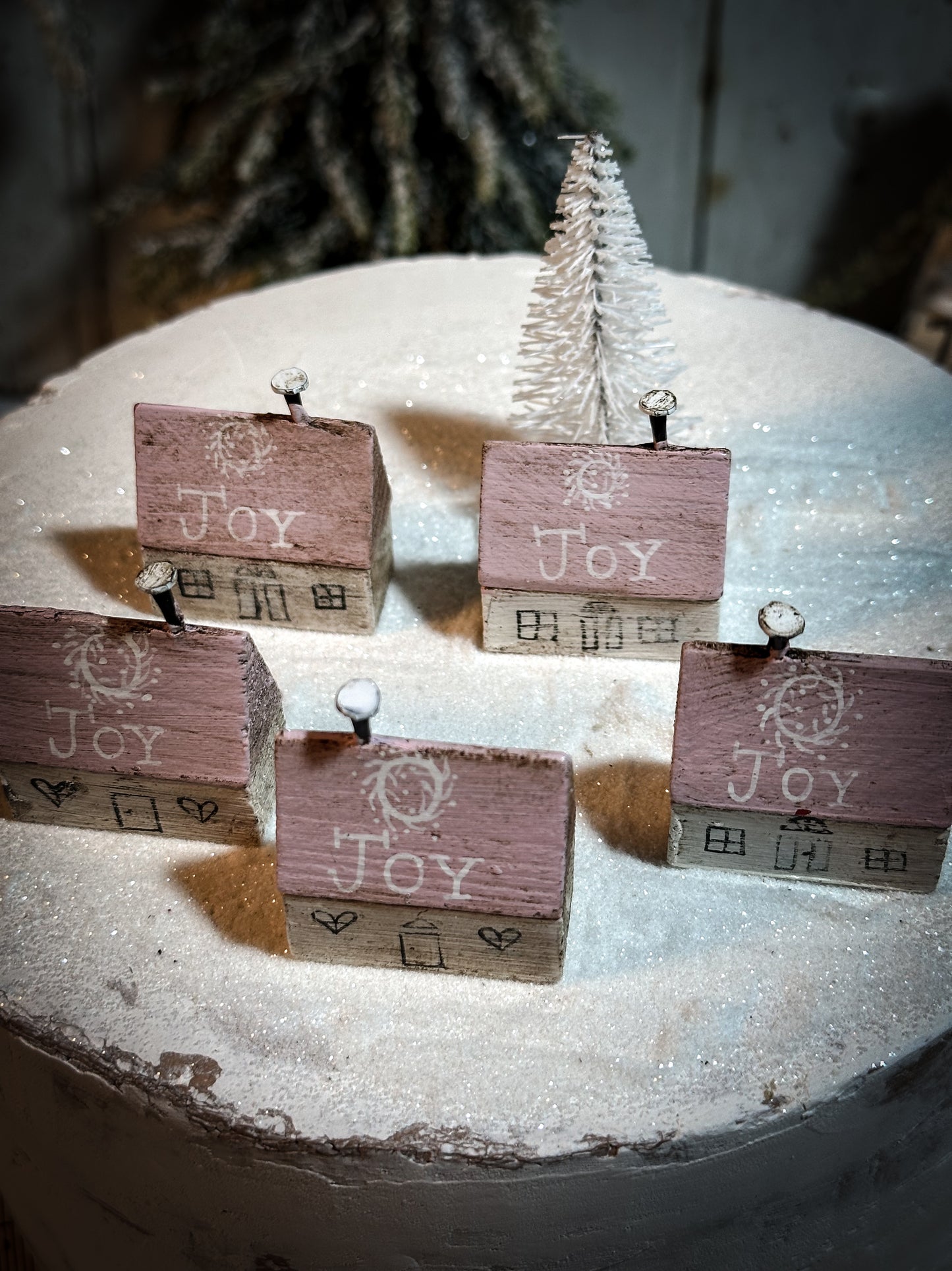 A pretty vintage German Erzgebirge Putz wooden village house painted with a Christmas quote