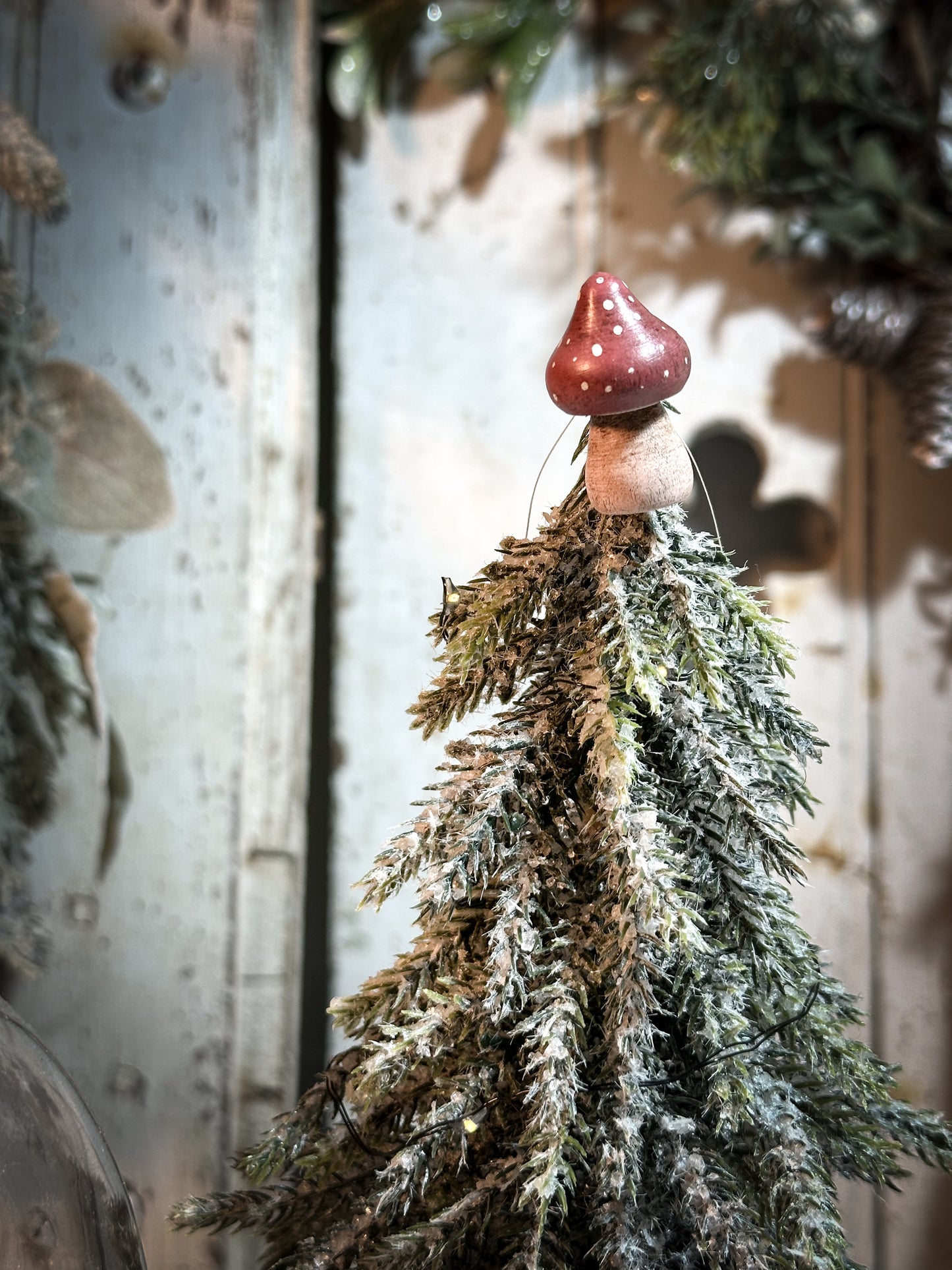 A wooden hand painted Christmas village toadstool