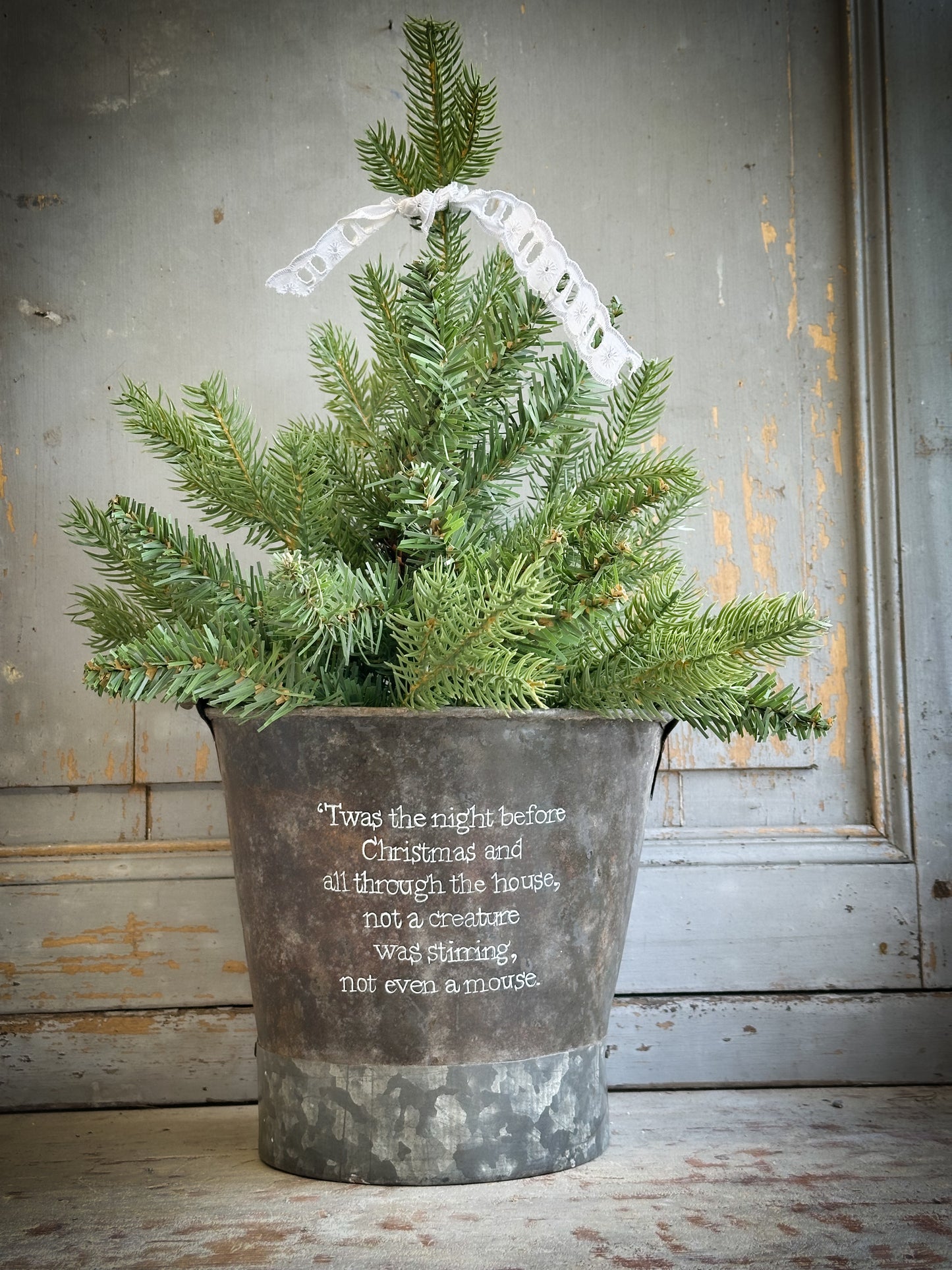 A Recycled Metal Small Christmas Tree Bucket With A Hand Painted Quote