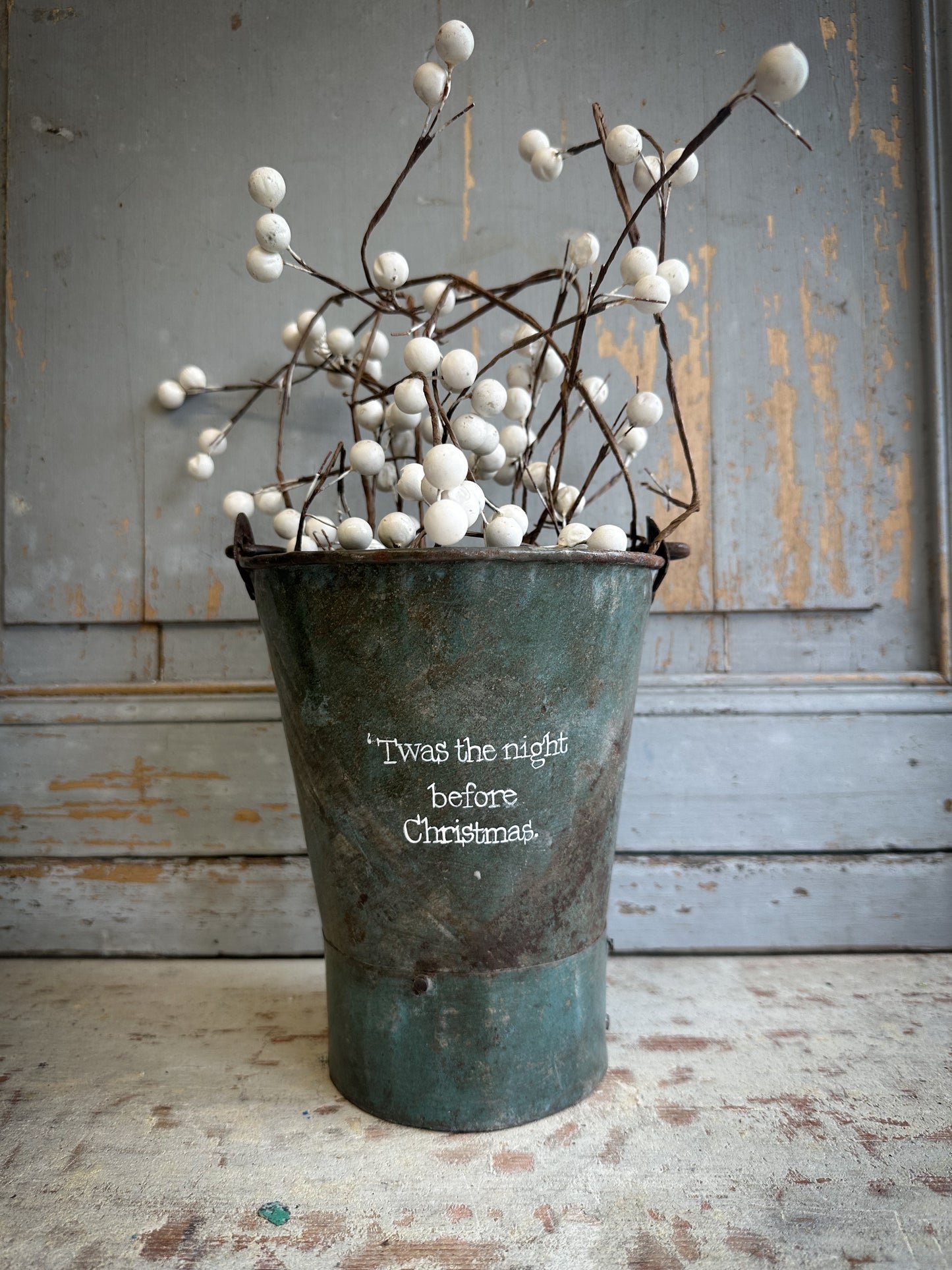 A Recycled Metal Mini Christmas Tree Bucket With A Hand Painted Quote
