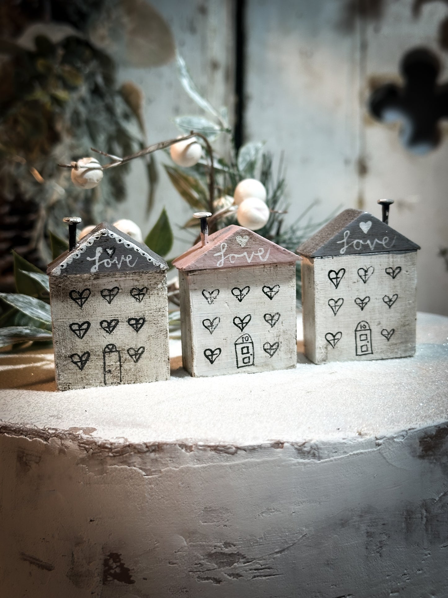 A pretty vintage German Erzgebirge Putz wooden village house painted with a Christmas quote