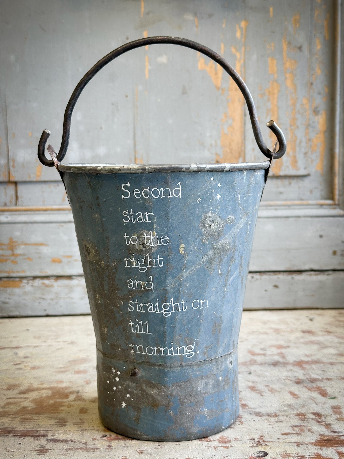 A Recycled Metal Mini Christmas Tree Bucket With A Hand Painted Quote