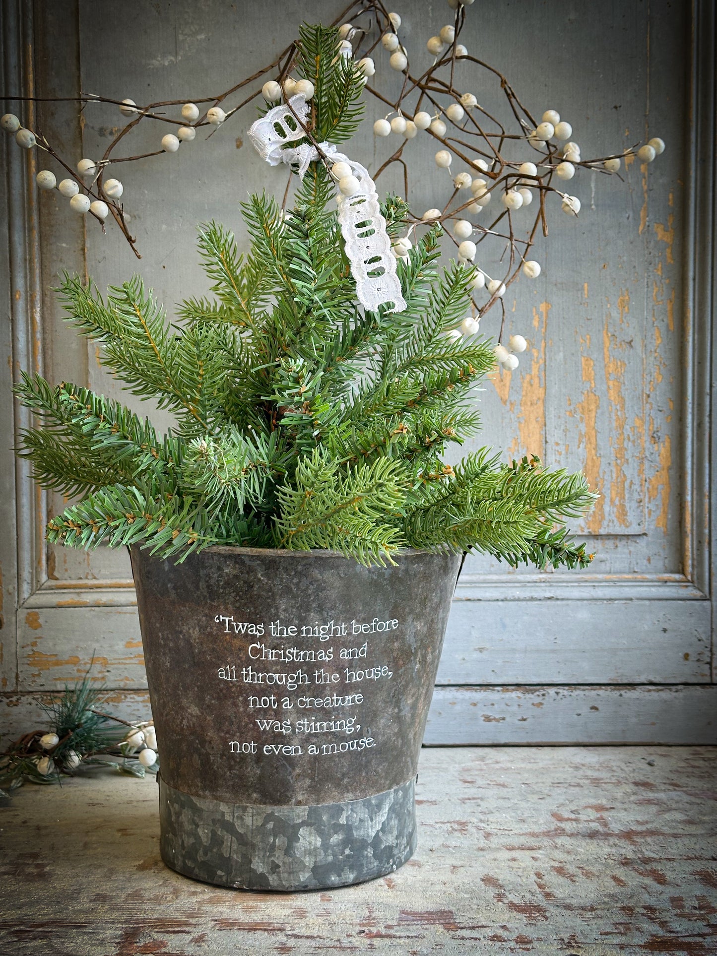 A Recycled Metal Small Christmas Tree Bucket With A Hand Painted Quote