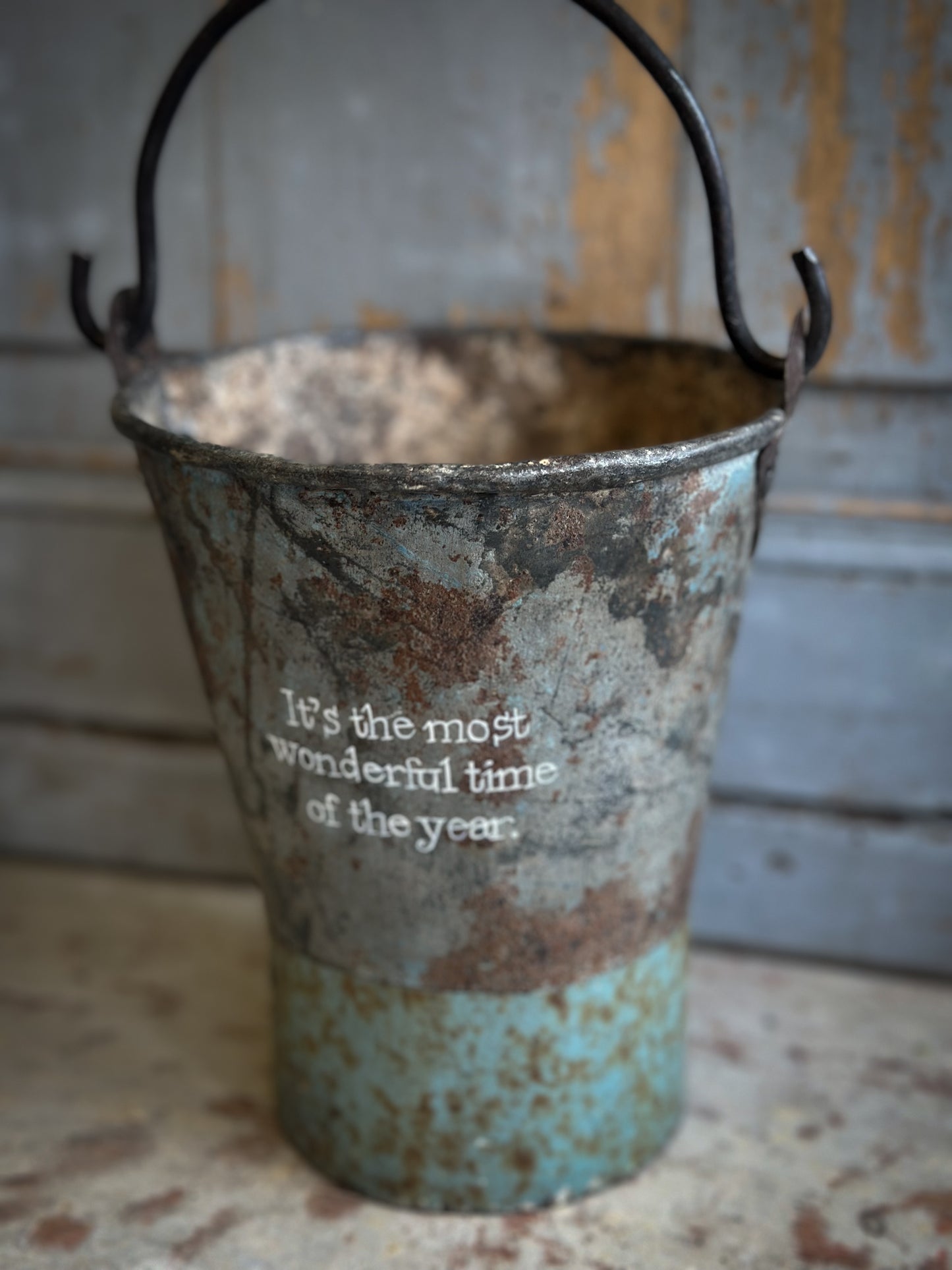 A Recycled Metal Mini Christmas Tree Bucket With A Hand Painted Quote
