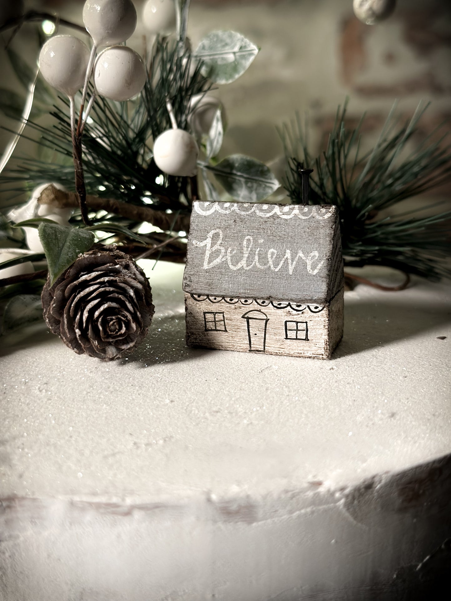 A pretty vintage German Erzgebirge Putz wooden village house painted with a Christmas quote