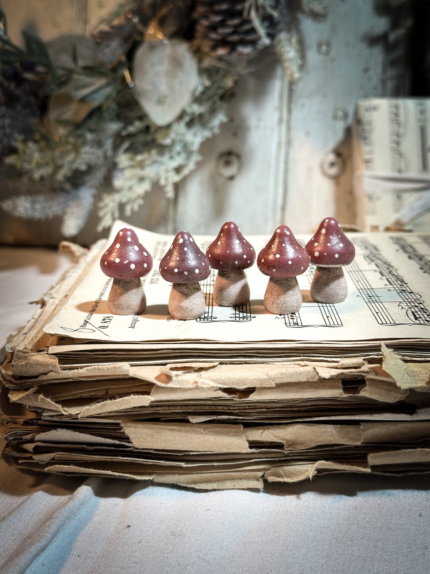 A wooden hand painted and trimmed Christmas village toadstool