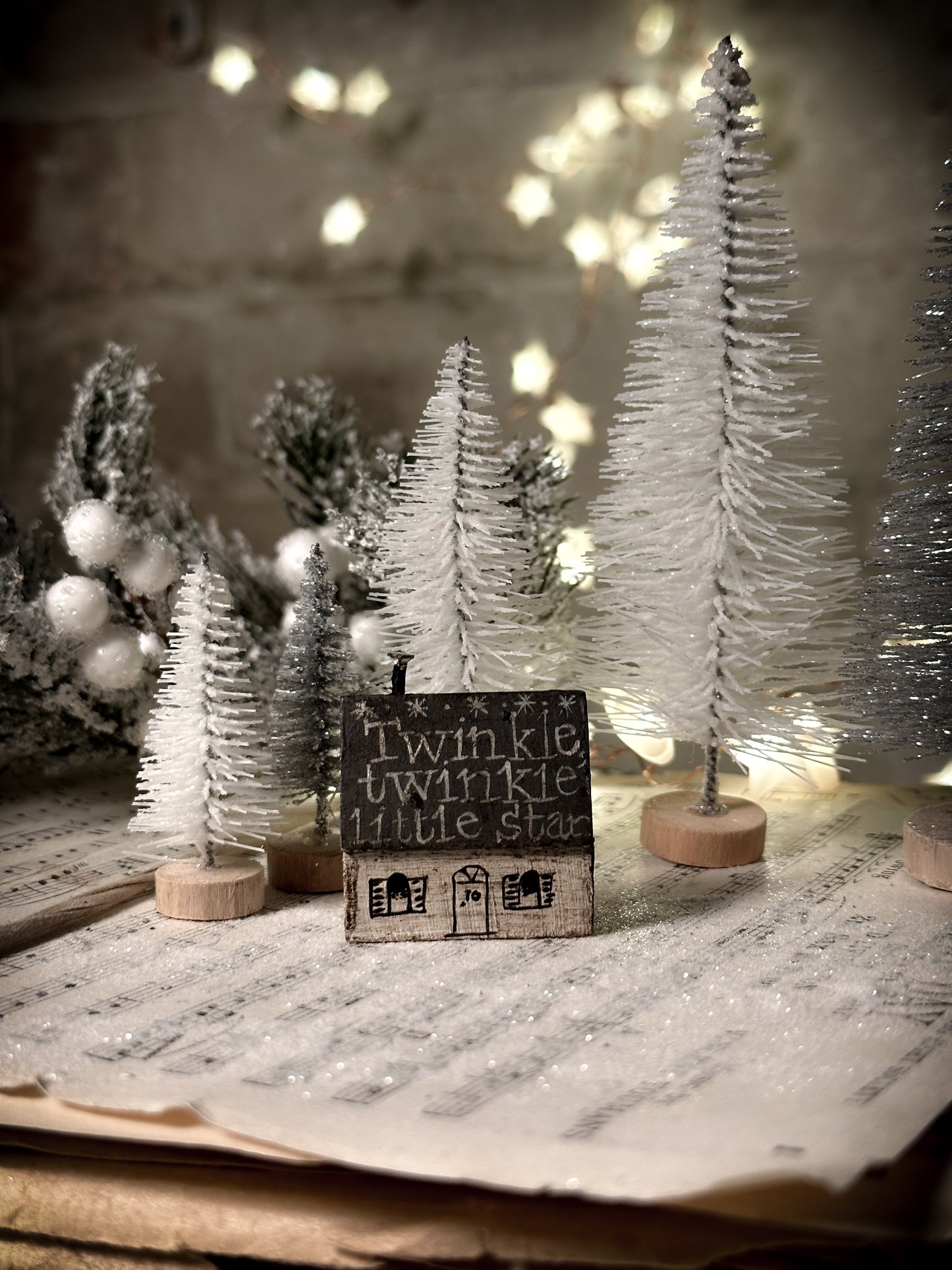 A pretty vintage German Erzgebirge Putz wooden village house painted with a Christmas quote
