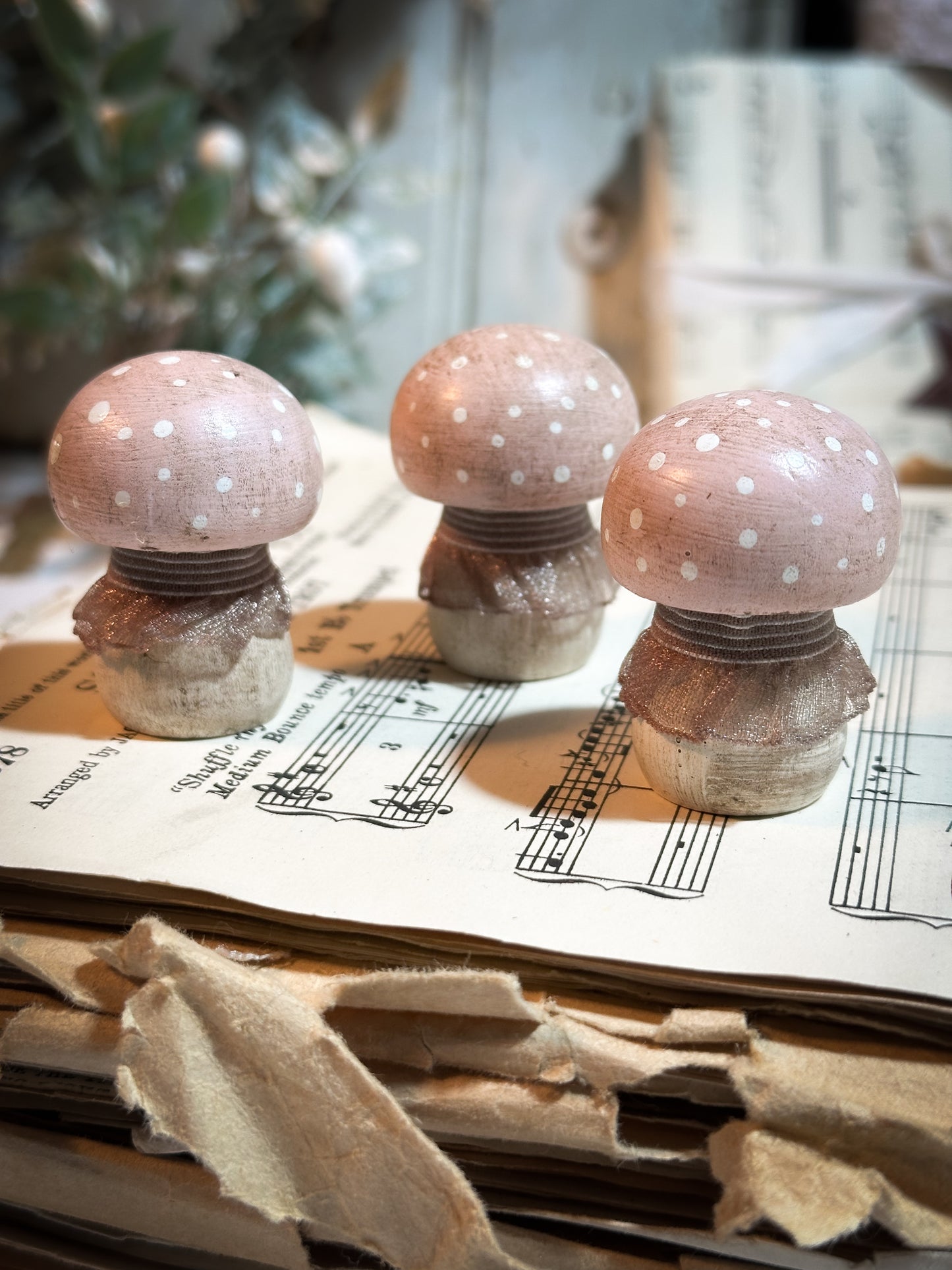 A wooden hand painted and trimmed Christmas village toadstool